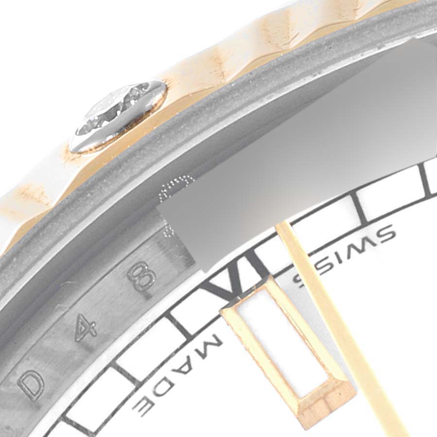 The image shows a close-up of the Rolex Mid-Size 178313 Women
s Steel and Gold (two tone) White Dial 178313 Women
s Steel and Gold (two tone) White Dial watch bezel, diamond marker, and partial dial.