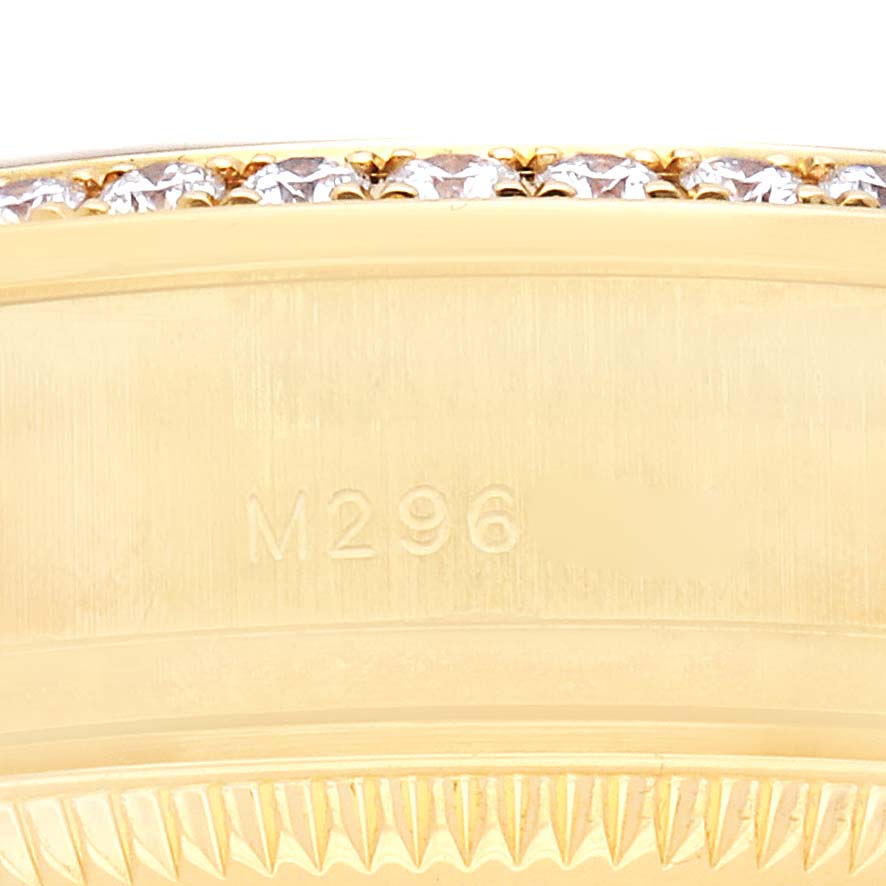 The image shows a close-up of the bezel with diamonds and part of the case of a Rolex President 179158 Women
s Yellow Gold Mother of Pearl Dial model watch.