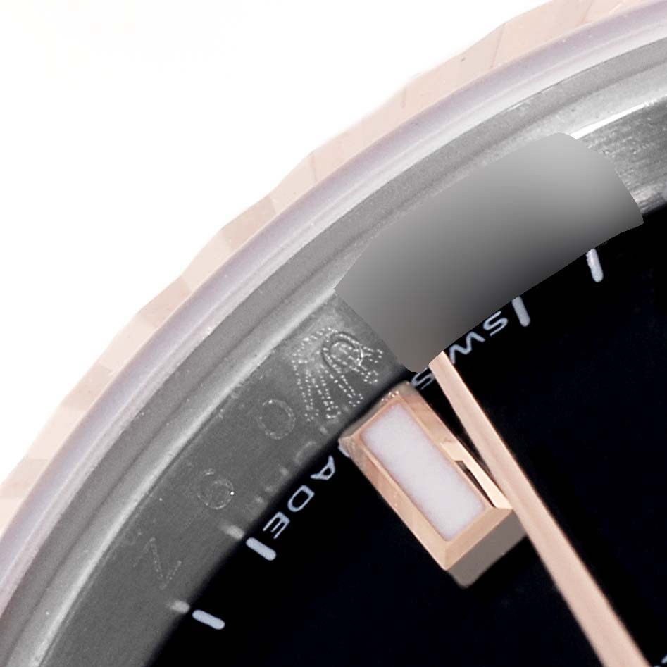This close-up angle of the Rolex Datejust 179171 Women's Steel and Gold (two tone) Black Dial 179171 Women's Steel and Gold (two tone) Black Dial model shows part of its bezel, dial, and a section of the hour marker.