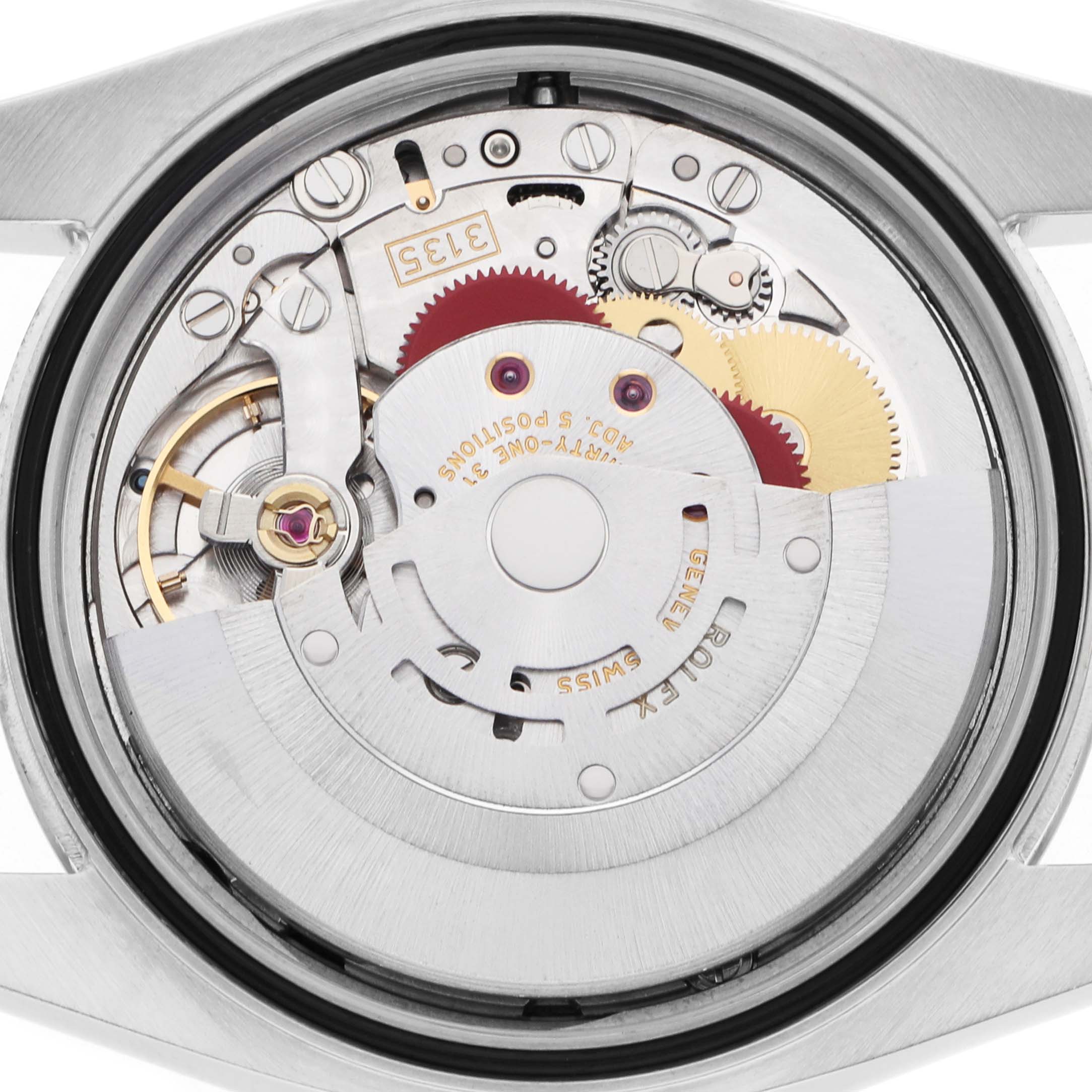 The Rolex Datejust 16234 Men
s Stainless Steel Black Dial watch is shown from the back, displaying its intricate mechanical movement and gears.