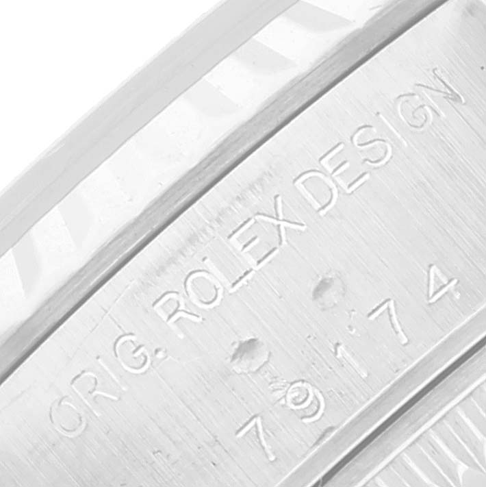 This close-up image shows the engraved watch case's inner side of the Rolex Datejust 79174 Women's Stainless Steel Mother of Pearl Dial 79174 Women's Stainless Steel Mother of Pearl Dial model, featuring the "ORIG. ROLEX DESIGN" inscription and model number.