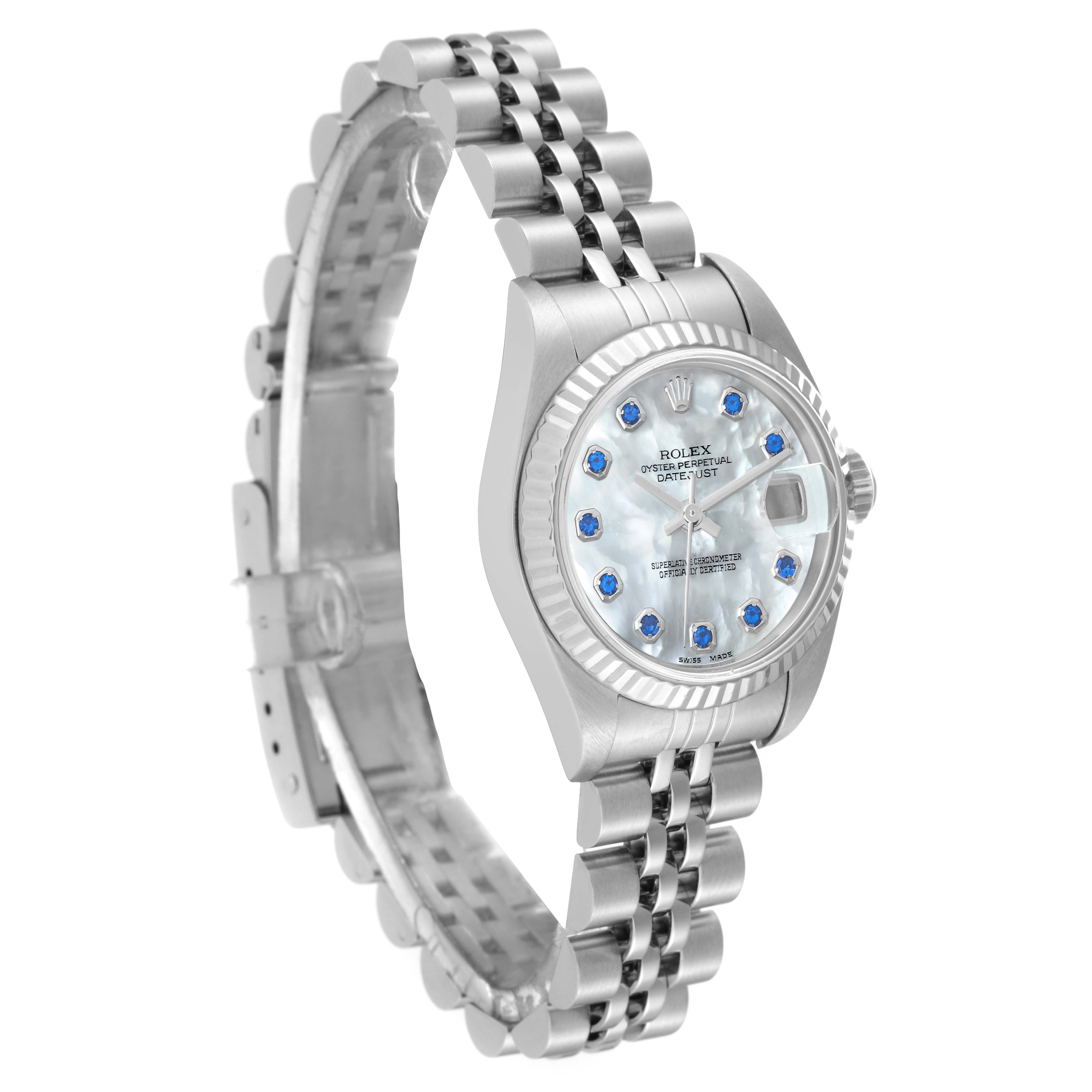 The image shows a side angle of a Rolex Datejust 79174 Women's Stainless Steel Mother of Pearl Dial 79174 Women's Stainless Steel Mother of Pearl Dial watch, highlighting its jubilee bracelet and mother-of-pearl dial with blue hour markers.