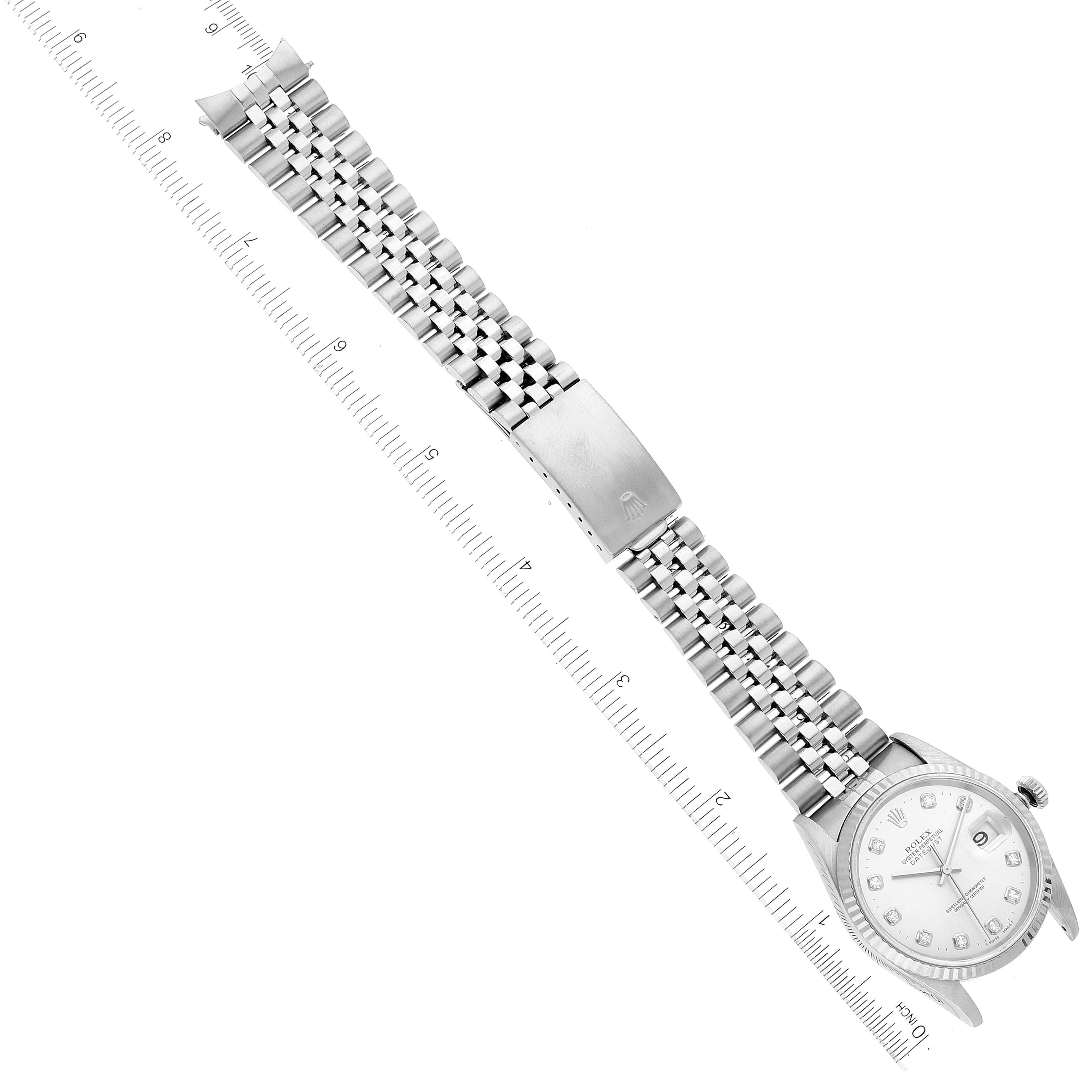 The image shows a Rolex Datejust 16234 Men's Stainless Steel Silver Dial 16234 Men's Stainless Steel Silver Dial watch laid flat with its jubilee bracelet and clasp extended, parallel to a measuring ruler.