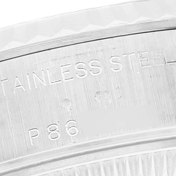 The image shows an extreme close-up of the case back engraving on a Rolex Datejust 79174 Women's Stainless Steel White Dial 79174 Women's Stainless Steel White Dial, highlighting the "STAINLESS STEEL" text.