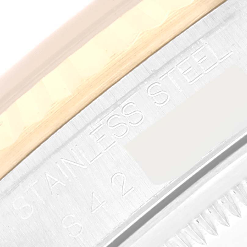 The image shows a close-up of the engraved stainless steel material on the side of a Rolex Datejust 16233 Men's Steel and Gold (two tone) Black Dial 16233 Men's Steel and Gold (two tone) Black Dial watch.