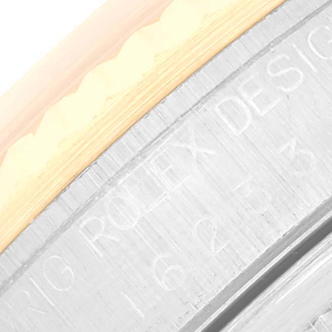The image shows a close-up of the side of the bezel with engraved text of a Rolex Datejust 16233 Men's Steel and Gold (two tone) Black Dial 16233 Men's Steel and Gold (two tone) Black Dial watch.
