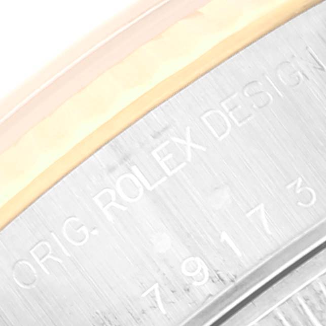 This close-up angle shows the side engraving on the case of a Rolex Datejust 79173 Women's Steel and Gold (two tone) Champagne Dial 79173 Women's Steel and Gold (two tone) Champagne Dial watch.