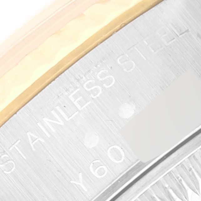 This image shows a close-up of the engravings on the metal case of a Rolex Datejust 79173 Women's Steel and Gold (two tone) Champagne Dial 79173 Women's Steel and Gold (two tone) Champagne Dial model watch.