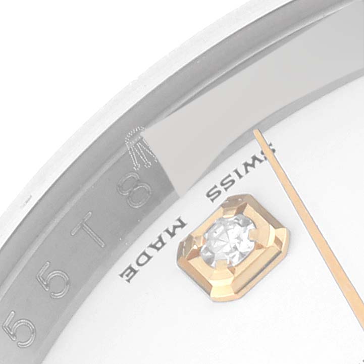 The image shows a close-up of the dial of a Rolex Datejust 116233 Men's Steel and Gold (two tone) White Dial 116233 Men's Steel and Gold (two tone) White Dial watch, highlighting the "Swiss Made" text, a gem marker, and part of the minute hand.