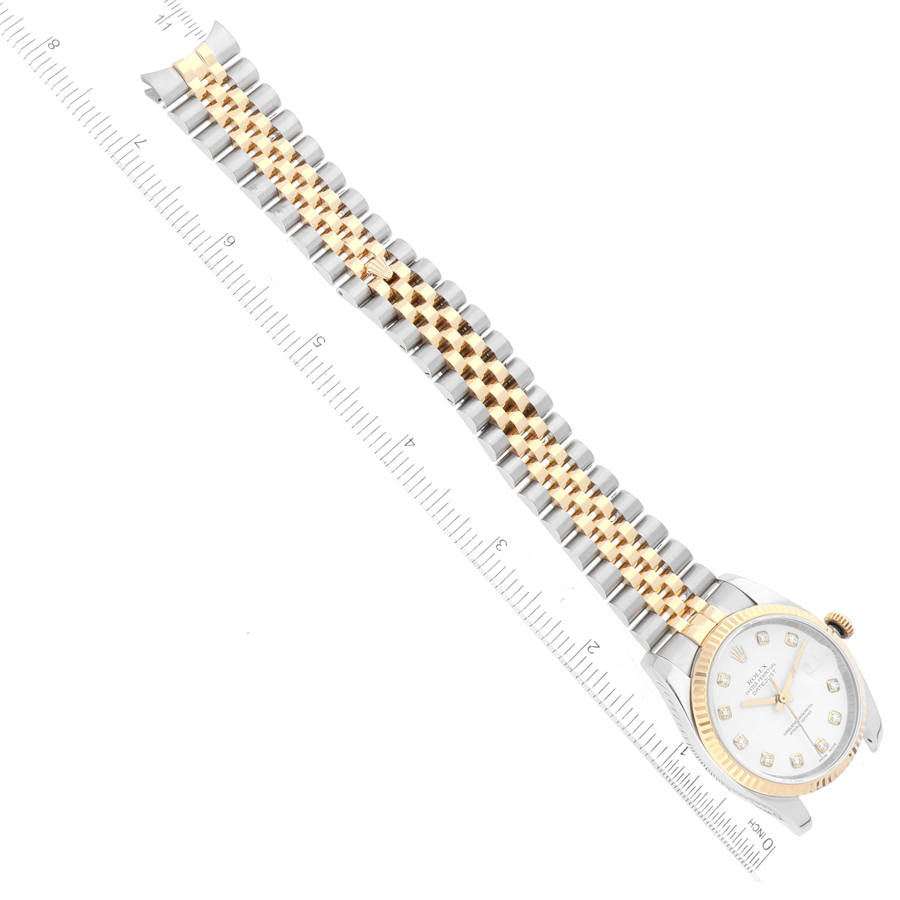 The Rolex Datejust 116233 Men's Steel and Gold (two tone) White Dial 116233 Men's Steel and Gold (two tone) White Dial watch is shown from an overhead angle, displaying the face, bezel, and full bracelet with a ruler for scale.