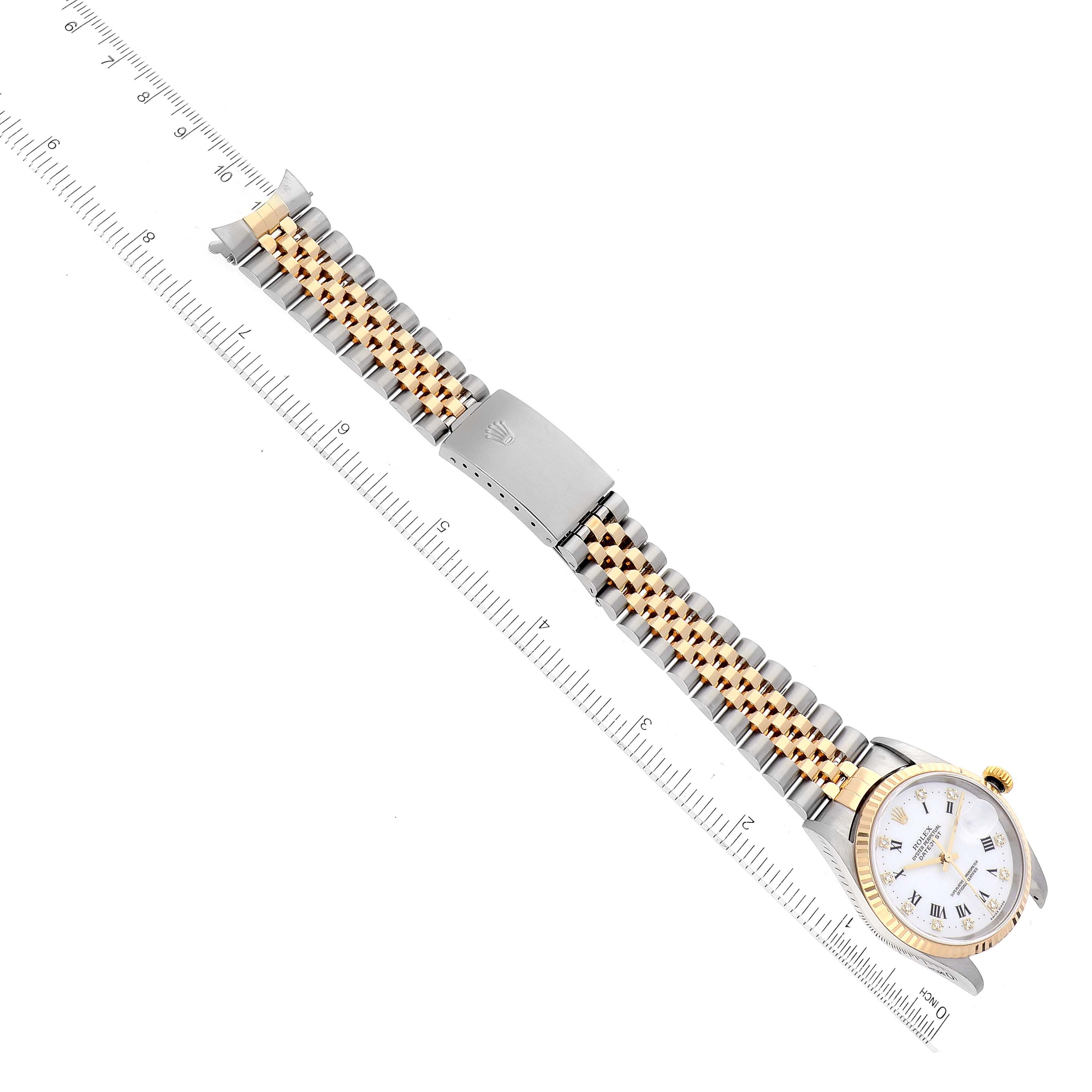 The image shows a Rolex Datejust 16233 Men's Steel and Gold (two tone) White Dial 16233 Men's Steel and Gold (two tone) White Dial watch horizontally placed next to a ruler, highlighting the bracelet and the watch face.