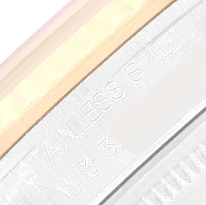 This photo shows a close-up of the stainless steel casing and part of the bezel of a Rolex Datejust 16233 Men's Steel and Gold (two tone) White Dial 16233 Men's Steel and Gold (two tone) White Dial watch.
