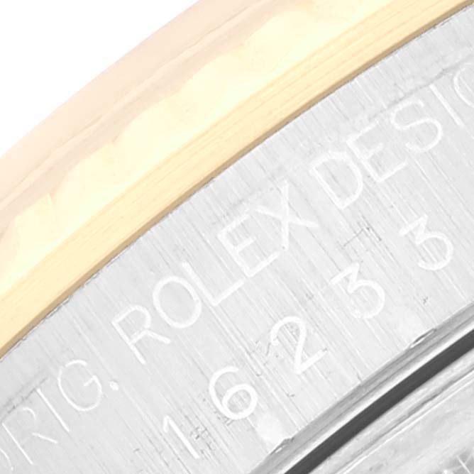 This close-up photo shows the engraved serial number and branding on the bezel edge of a Rolex Datejust 16233 Men's Steel and Gold (two tone) White Dial 16233 Men's Steel and Gold (two tone) White Dial watch.