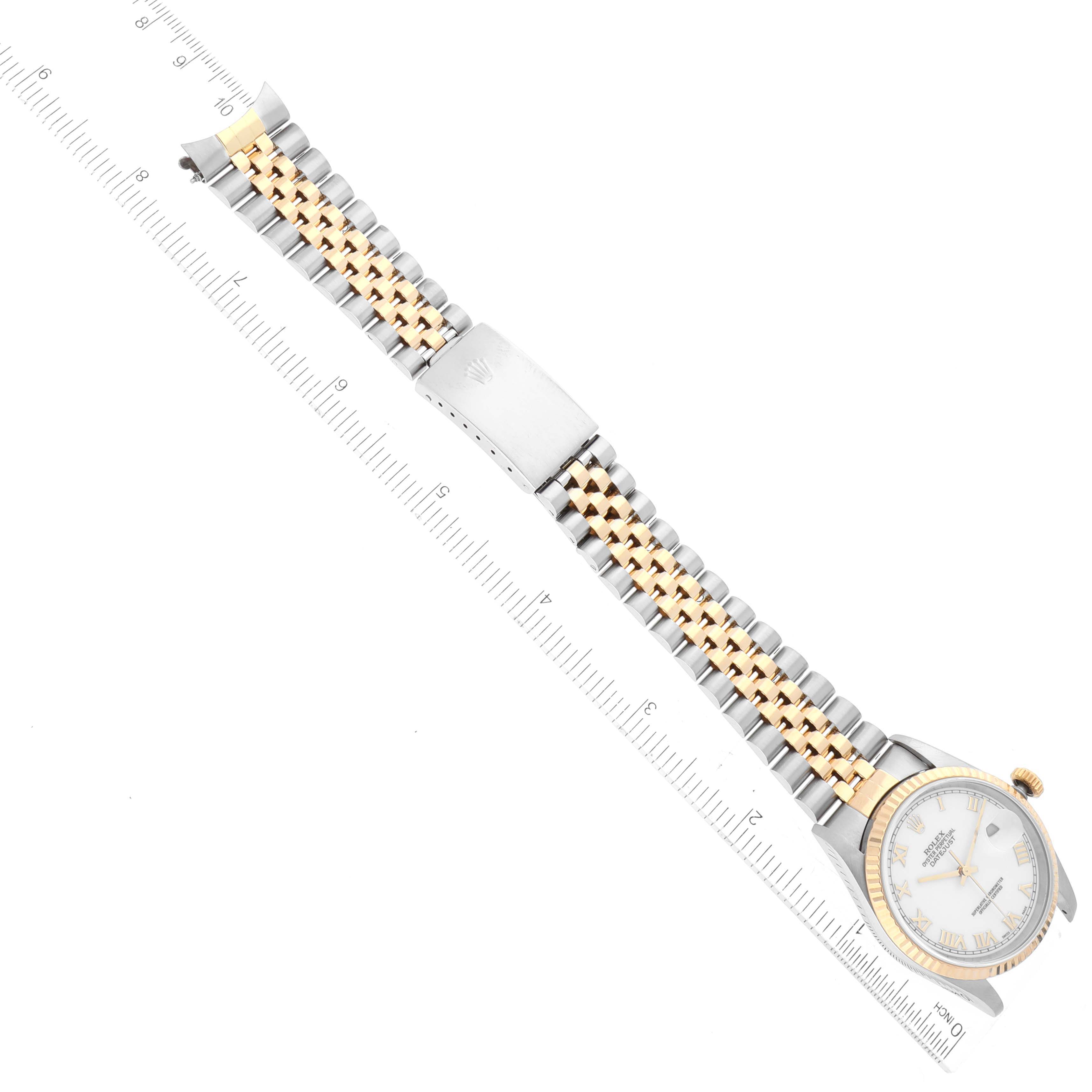 The image shows a top-down view of a Rolex Datejust 16233 Men's Steel and Gold (two tone) White Dial 16233 Men's Steel and Gold (two tone) White Dial watch, displaying the full bracelet, watch face, and ruler for scale.