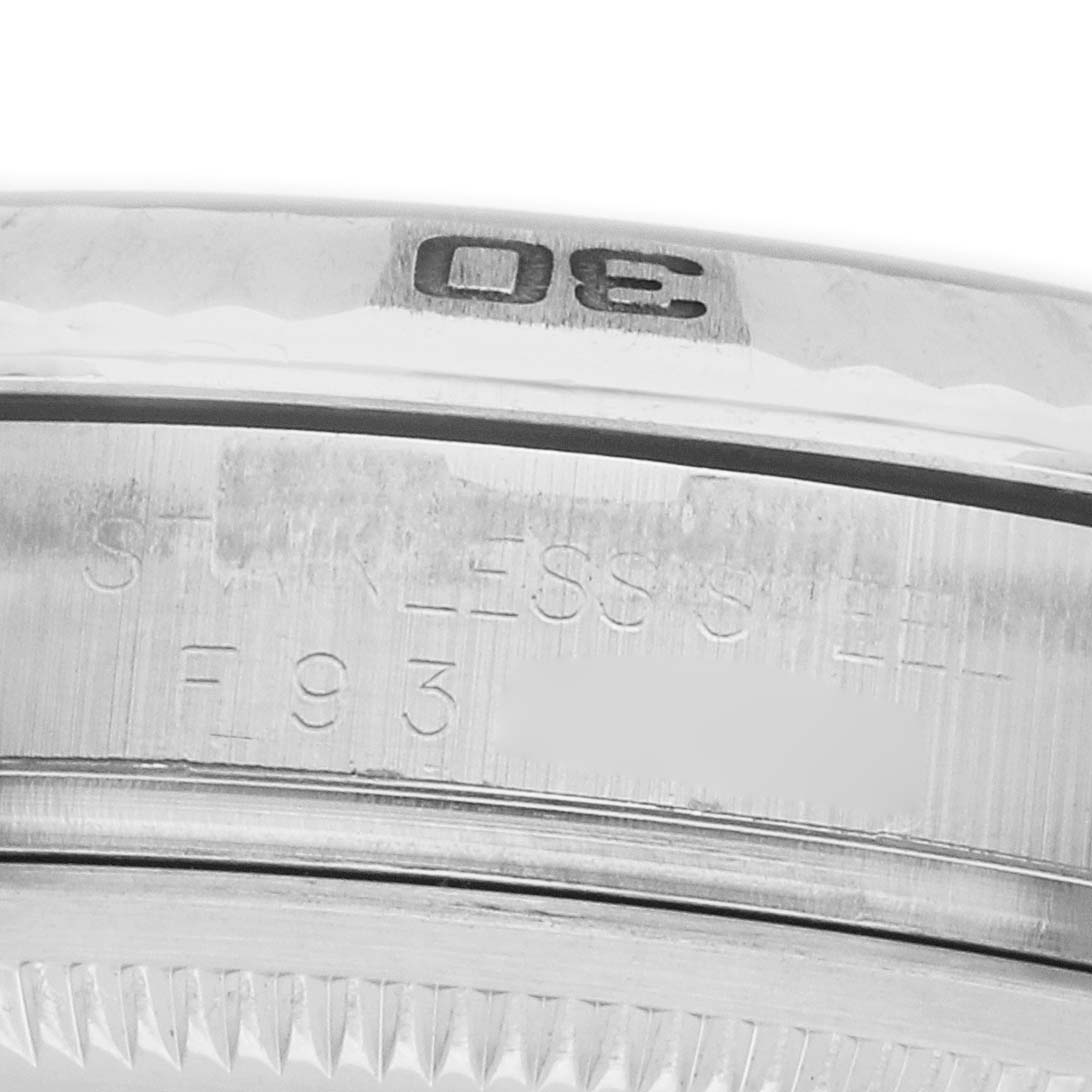 The image shows a close-up of the stainless steel bezel and side engraving of the Rolex Datejust 116264 Men
s Stainless Steel Blue Dial watch.