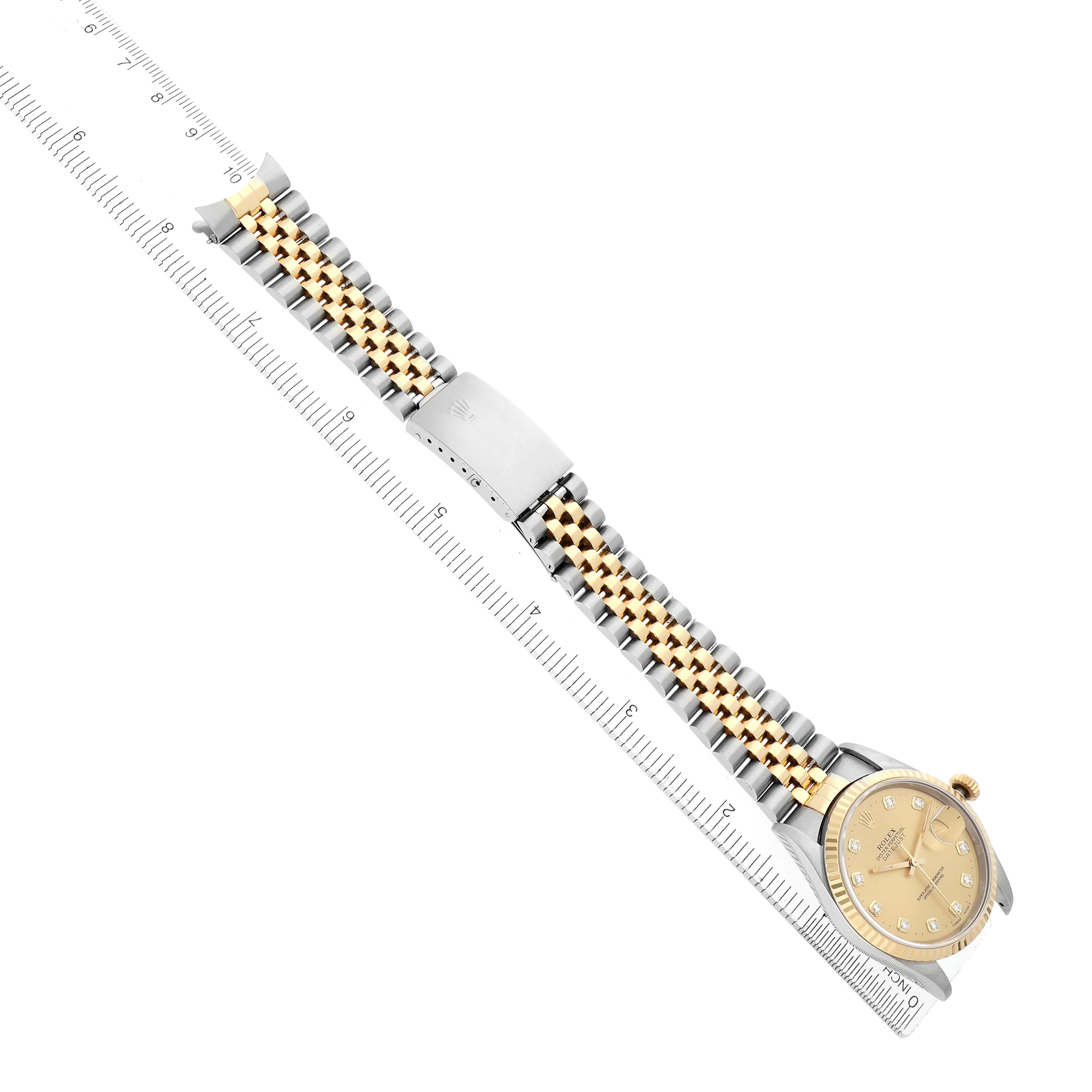 The Rolex Datejust 16233 Men
s Steel and Gold (two tone) Champagne Dial watch is shown from a top-down angle, highlighting the bracelet and dial alongside a ruler for scale.