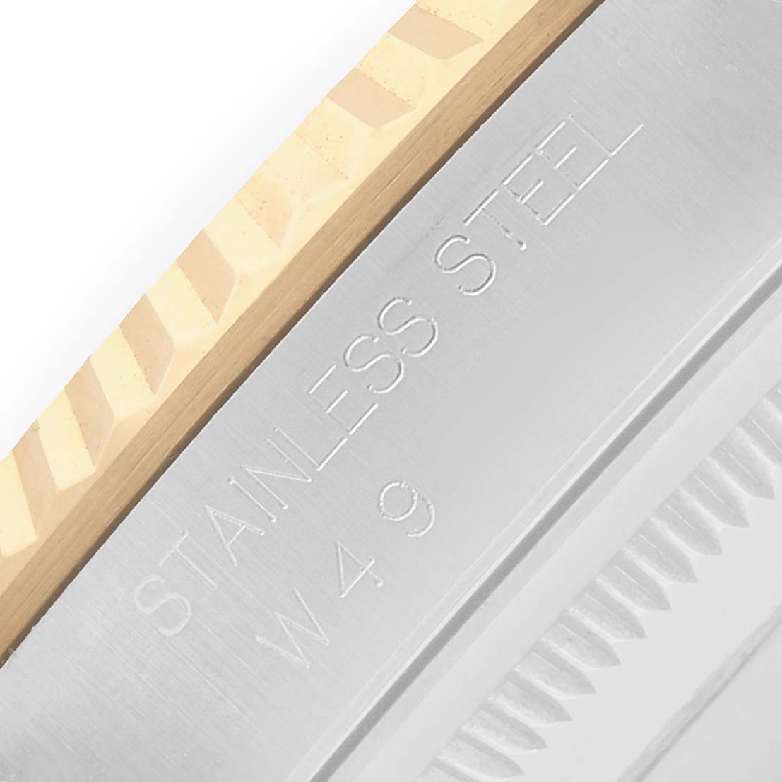 The image shows a close-up of the Rolex Datejust 16233 Men
s Steel and Gold (two tone) Champagne Dial
s bezel, highlighting the fluted gold and engraved stainless steel sections.