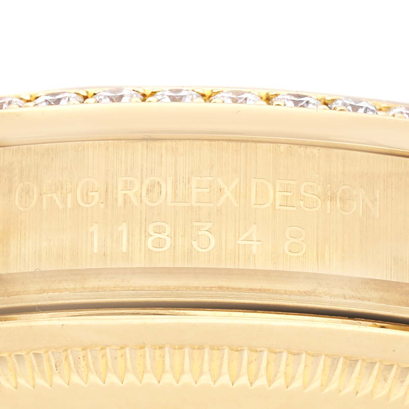 The image shows a close-up side view of the Rolex President 118348 Men
s Yellow Gold Mother of Pearl Dial 118348 Men
s Yellow Gold Mother of Pearl Dial model, focusing on the engraved case and bezel with diamonds.