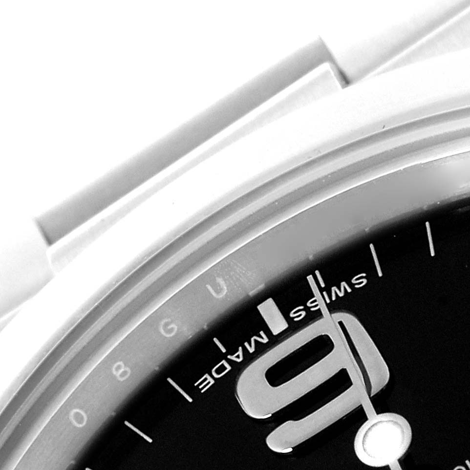 The image shows a close-up of the Rolex Explorer 214270 Men
s Stainless Steel Black Dial 214270 Men
s Stainless Steel Black Dial watch’s dial, focusing on the numeral and "Swiss Made" text.