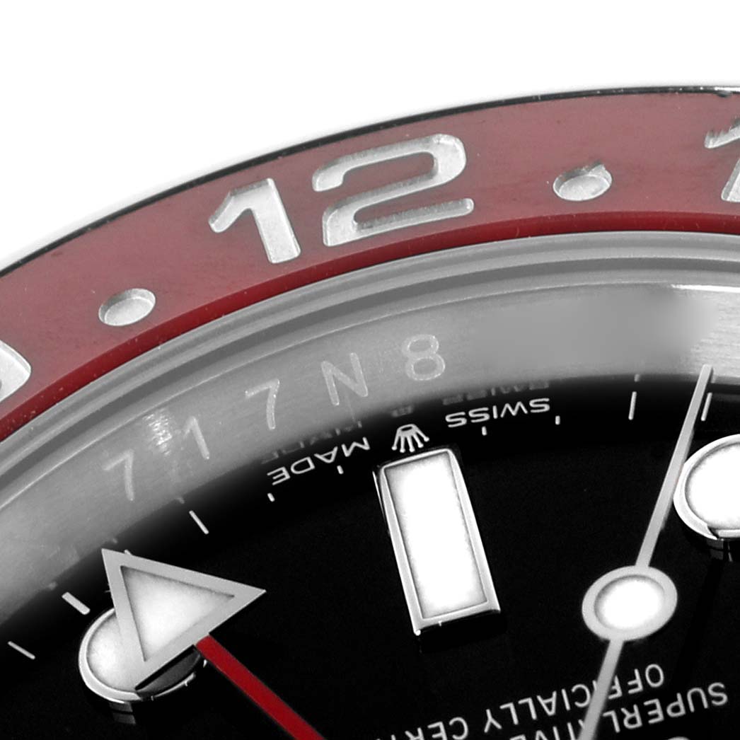 The image shows a close-up of the Rolex GMT-Master 126710BLRO Men's Stainless Steel Black Dial 126710BLRO Men's Stainless Steel Black Dial bezel with part of the dial and one of the watch hands visible.