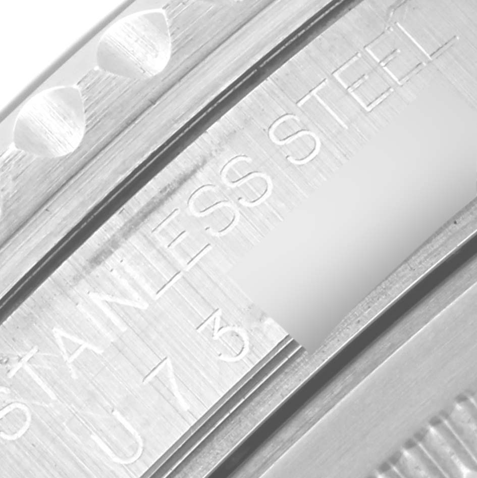 The image shows a close-up of the side view of a Rolex GMT-Master 16700 Men
s Stainless Steel Black Dial 16700 Men
s Stainless Steel Black Dial, highlighting the "STAINLESS STEEL" engraving.