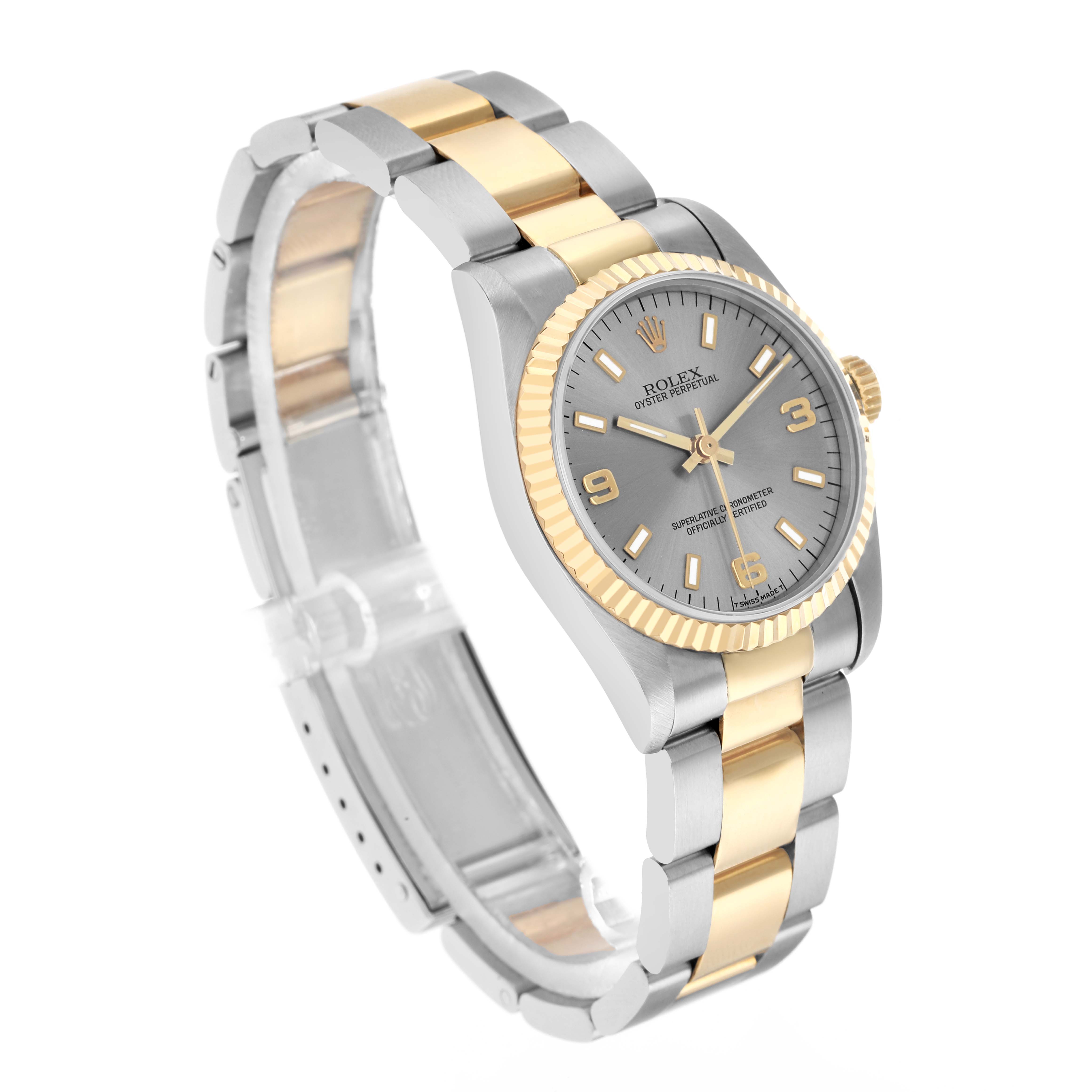 The Rolex Oyster Perpetual 67513 Women
s Steel and Gold (two tone) Silver Dial is shown from a front-left angle, displaying the watch face, bezel, and bracelet links.