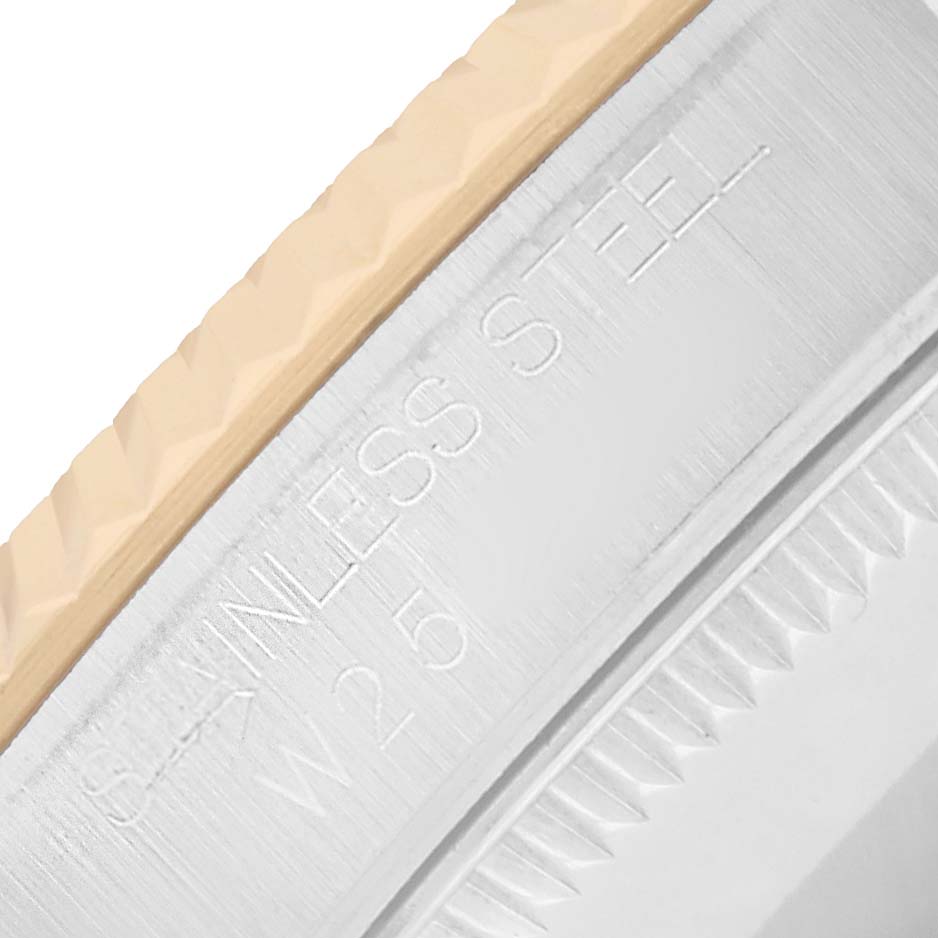 The image shows a close-up of the bezel edge and engraved text on a stainless steel part of a Rolex Oyster Perpetual 67513 Women
s Steel and Gold (two tone) Silver Dial watch.