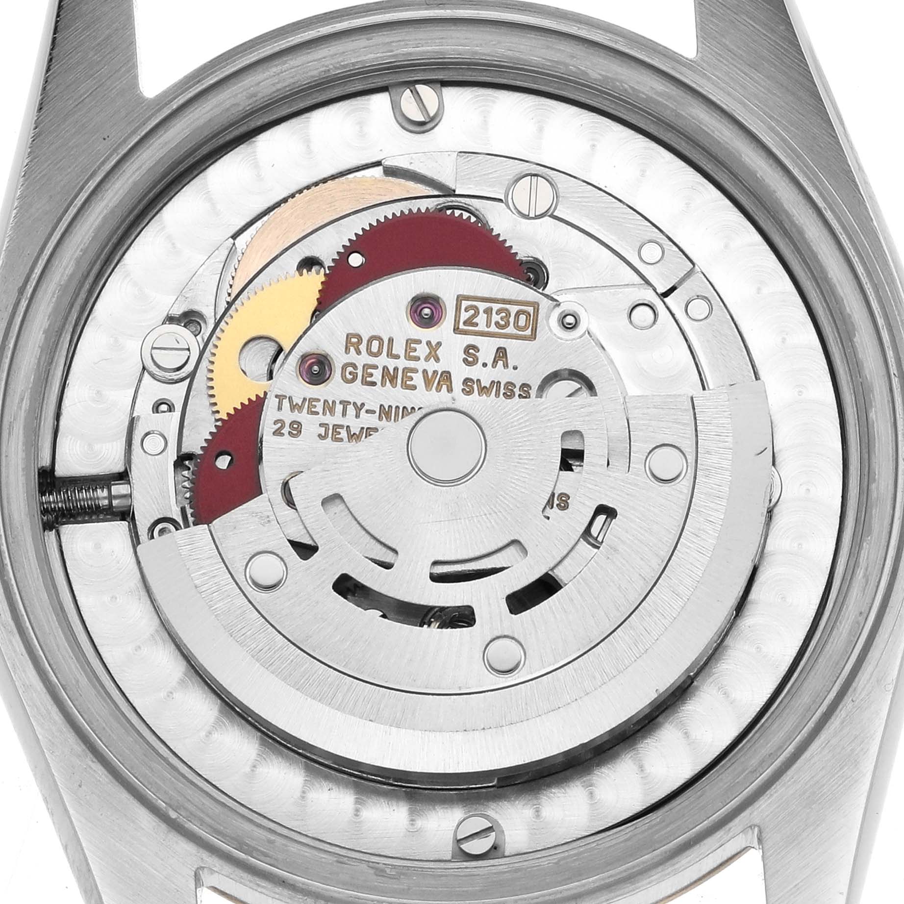 The image shows the movement of a Rolex Oyster Perpetual 67513 Women
s Steel and Gold (two tone) Silver Dial watch from the back, highlighting its gears and rotor mechanism.