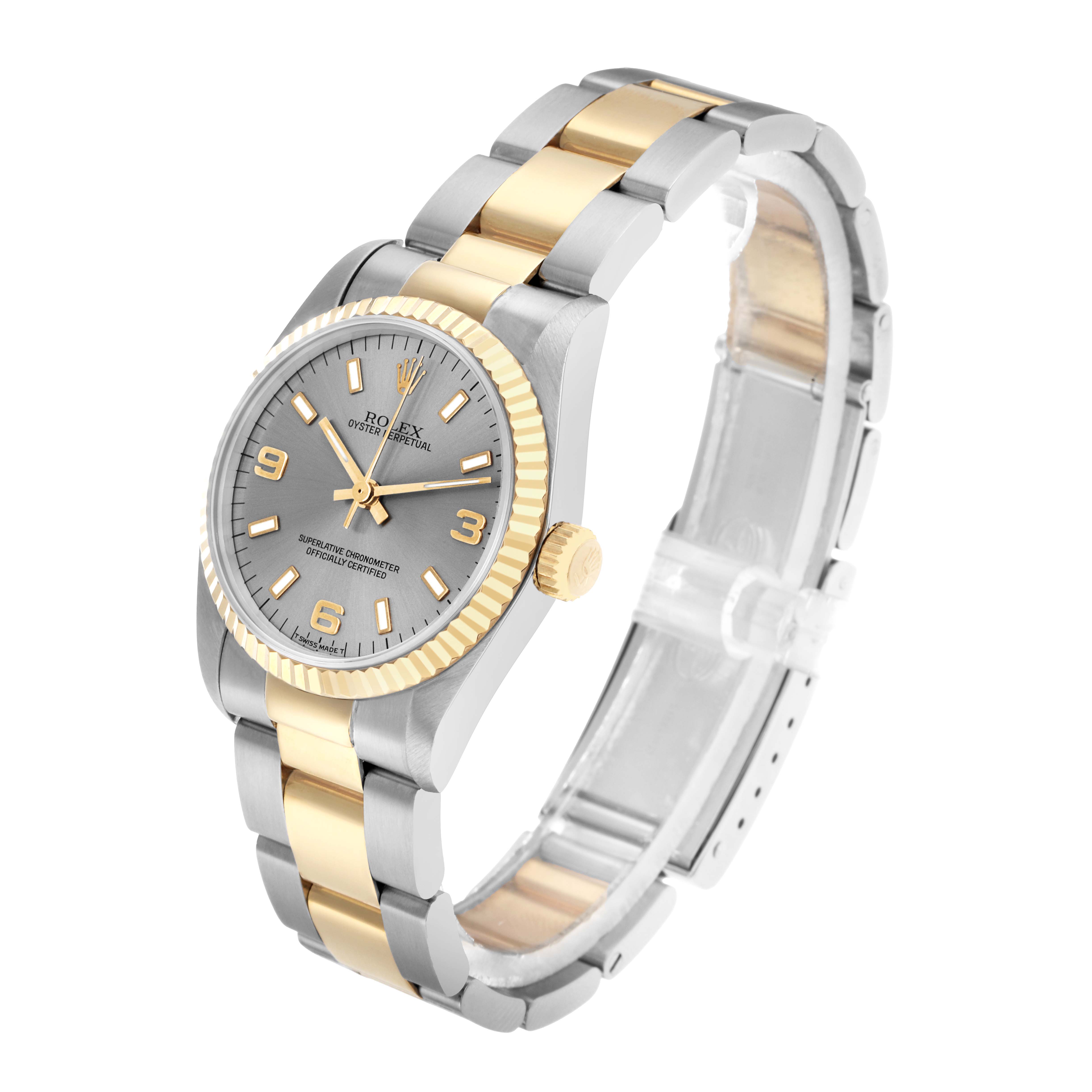 The Rolex Oyster Perpetual 67513 Women
s Steel and Gold (two tone) Silver Dial watch is shown at a three-quarter angle, displaying the face, bracelet, and crown.