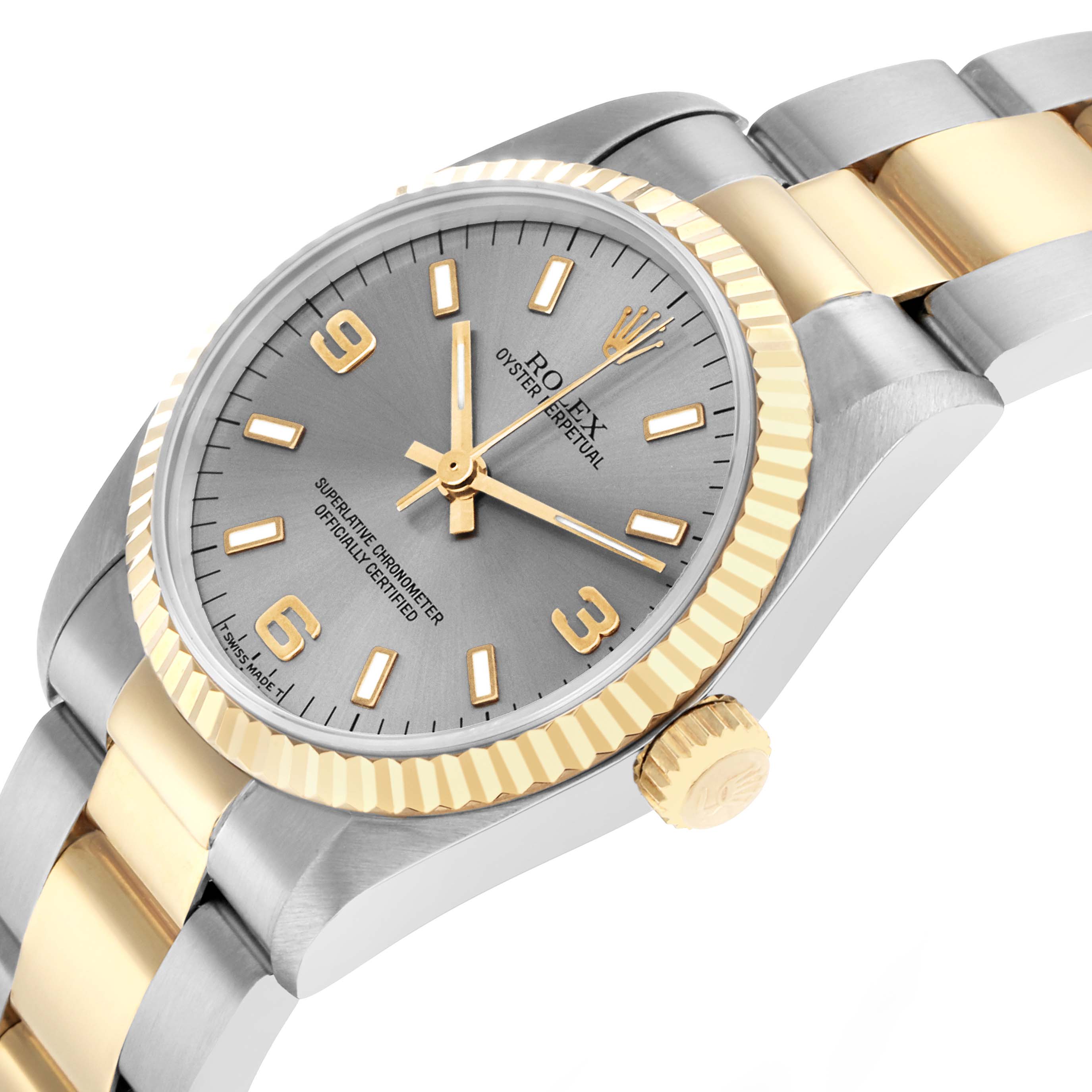 The image shows a Rolex Oyster Perpetual 67513 Women
s Steel and Gold (two tone) Silver Dial watch at a tilted angle, highlighting the dial, crown, and bracelet.