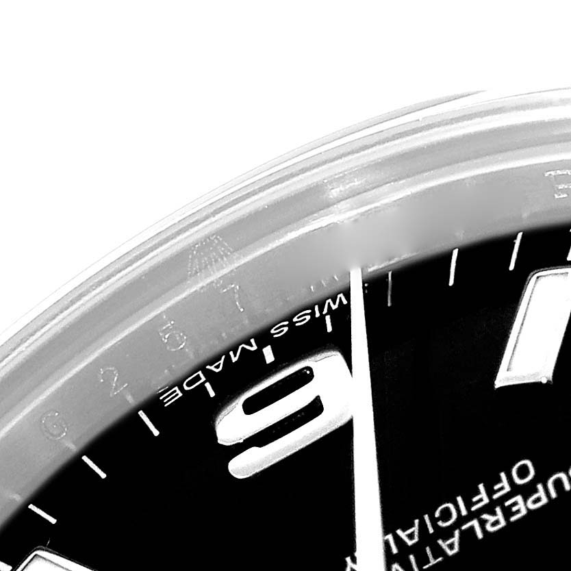 The image shows a close-up angle of the dial for a Mid-Size Rolex watch, prominently featuring the number "9" and "Swiss Made".