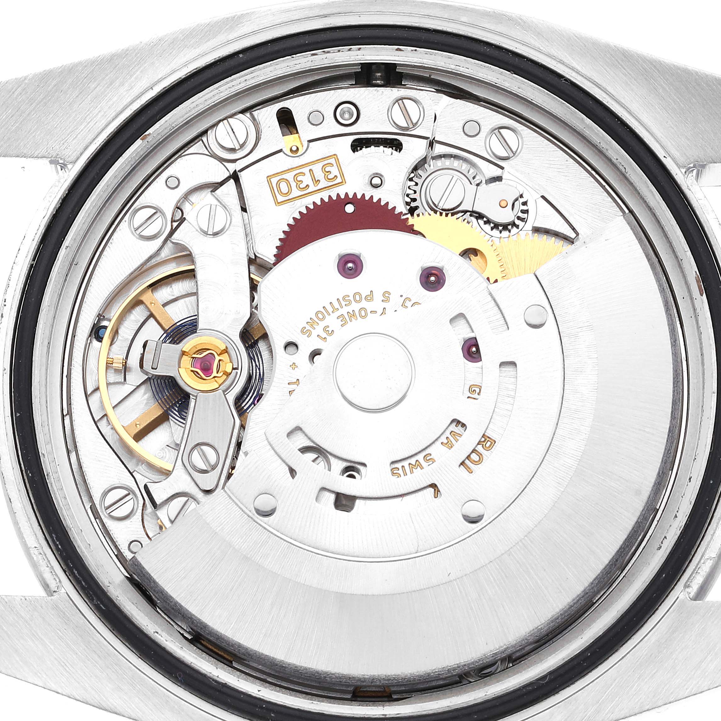 The image shows a close-up view of the movement mechanism of a Rolex Oyster Perpetual 116000 Men
s Stainless Steel Purple Dial 116000 Men
s Stainless Steel Purple Dial watch.