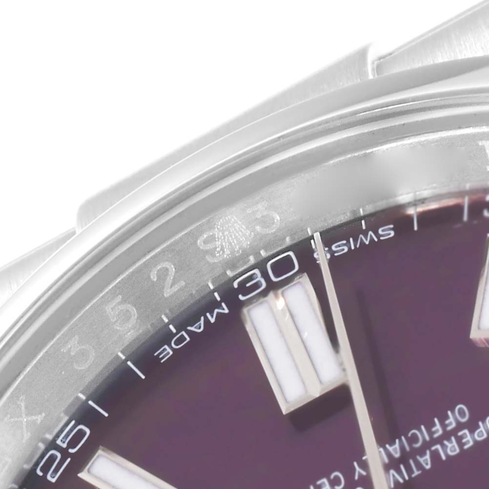 This close-up image shows the top portion of the dial and bezel of a Rolex Oyster Perpetual 116000 Men
s Stainless Steel Purple Dial 116000 Men
s Stainless Steel Purple Dial watch.