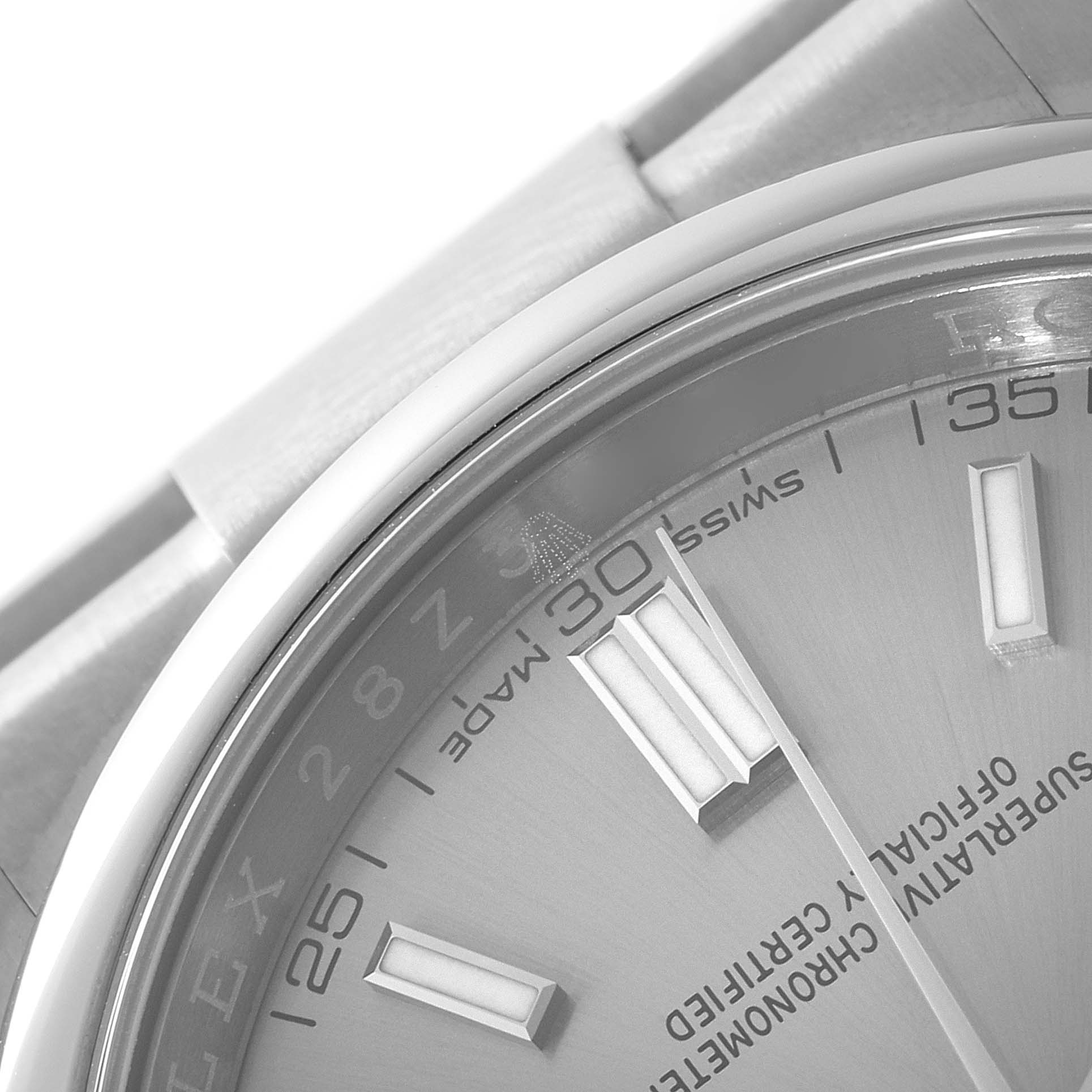 The image shows a close-up of the dial and part of the bracelet of a Rolex Oyster Perpetual 116000 Men
s Stainless Steel Grey Dial 116000 Men
s Stainless Steel Grey Dial watch.