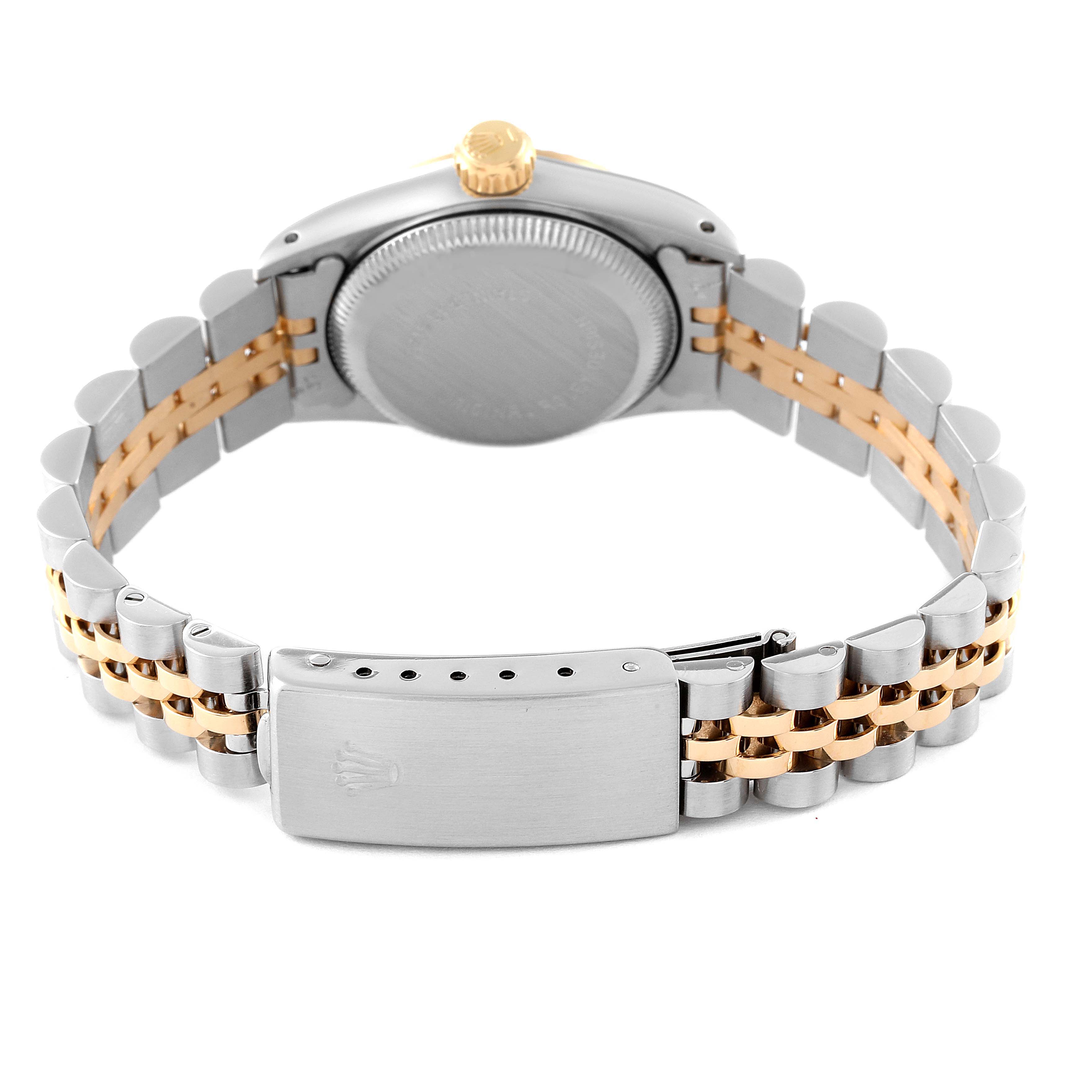 The image shows the back view of a Rolex Oyster Perpetual 67193 Women
s Steel and Gold (two tone) White Dial 67193 Women
s Steel and Gold (two tone) White Dial watch, highlighting its steel and gold bracelet and clasp.