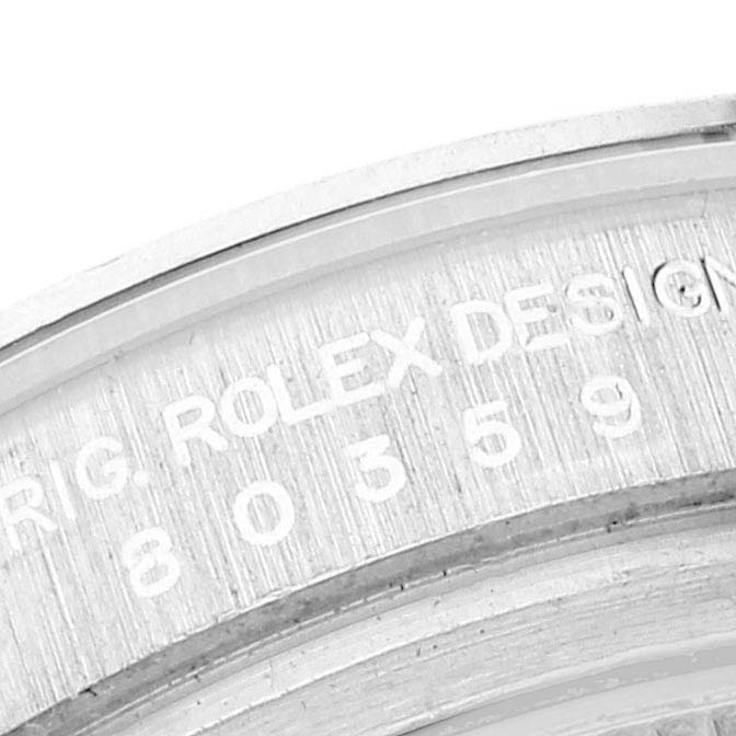 This image shows a close-up of the Rolex Pearlmaster 80359 Women's White Gold Mother of Pearl Dial 80359 Women's White Gold Mother of Pearl Dial watch's engraved bezel and case back.
