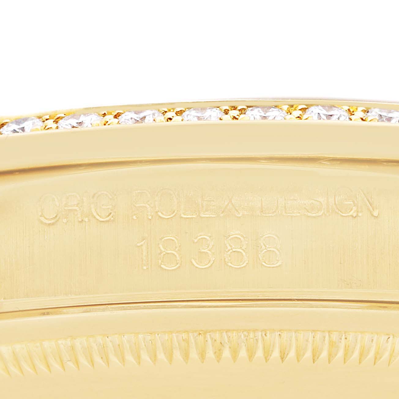 The image shows a close-up of the bezel and case side of the Rolex President 18388 Men
s Yellow Gold Champagne Dial model, revealing engraved text and a diamond-set bezel.