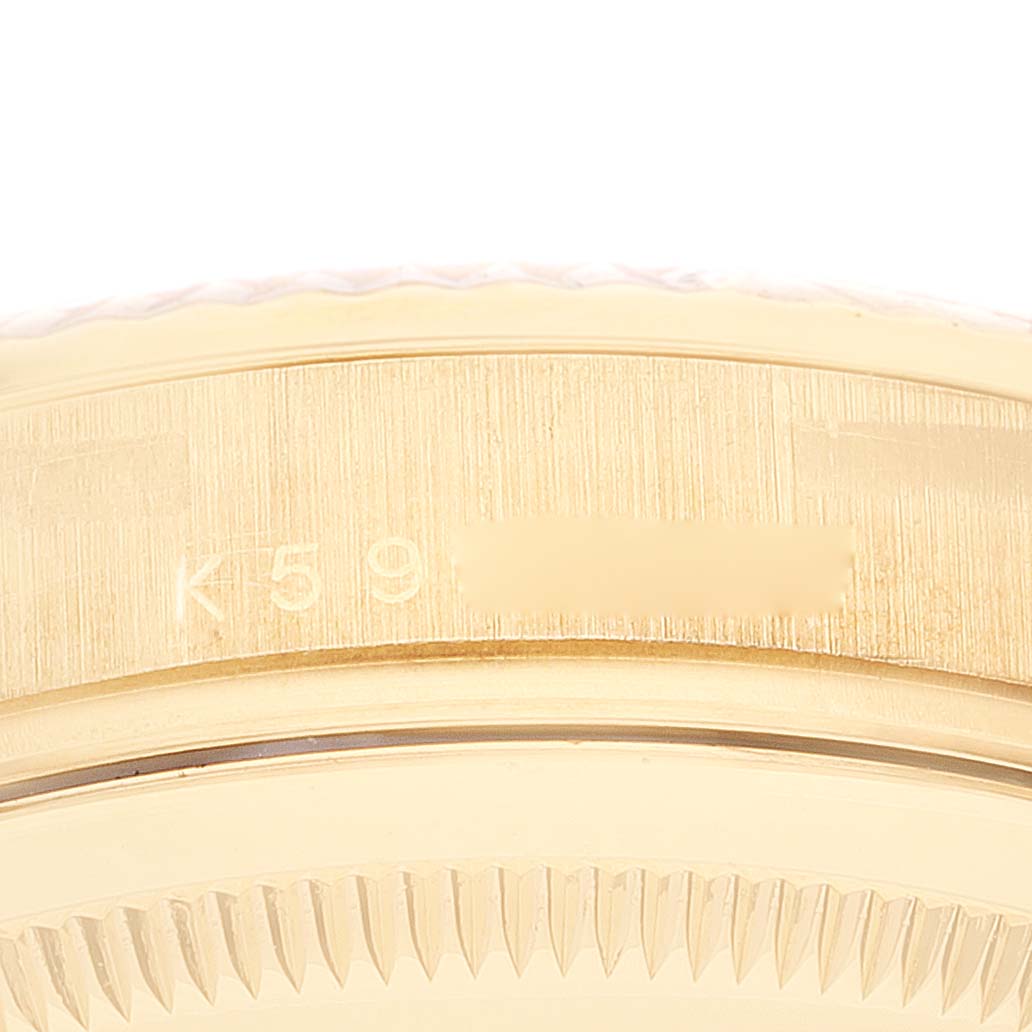 The image shows a close-up of the side casing and fluted bezel of a Rolex President 118338 Men's Yellow Gold  118338 Men's Yellow Gold  model watch.