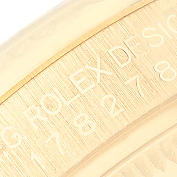 This close-up image showcases the engraved inner bezel of a Rolex President 178278 Women's Yellow Gold Mother of Pearl Dial 178278 Women's Yellow Gold Mother of Pearl Dial model watch.