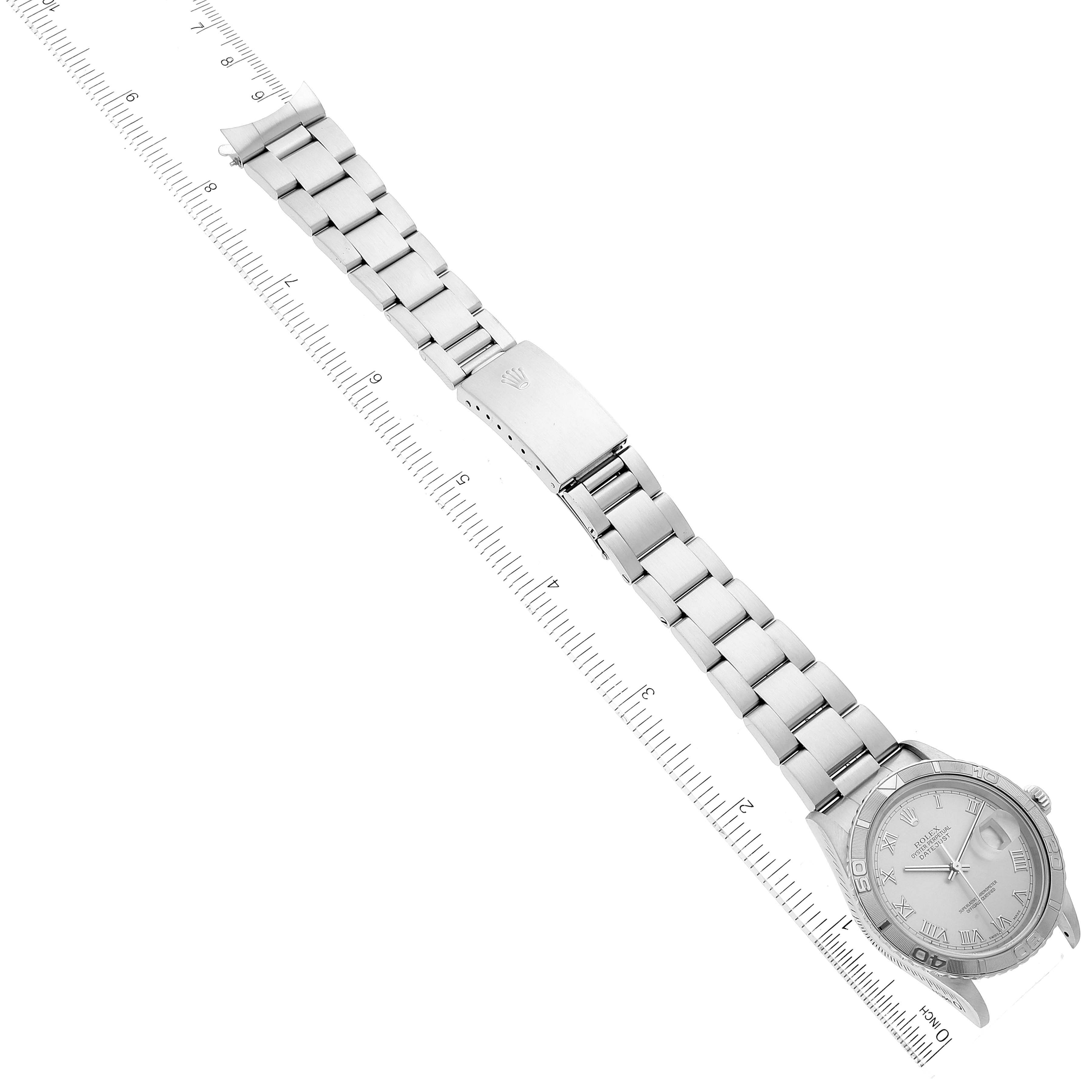 This image shows a top-down view of a Rolex Datejust 16264 Men's Stainless Steel Silver Dial 16264 Men's Stainless Steel Silver Dial watch, displaying the dial, bracelet, and clasp with a ruler for scale.