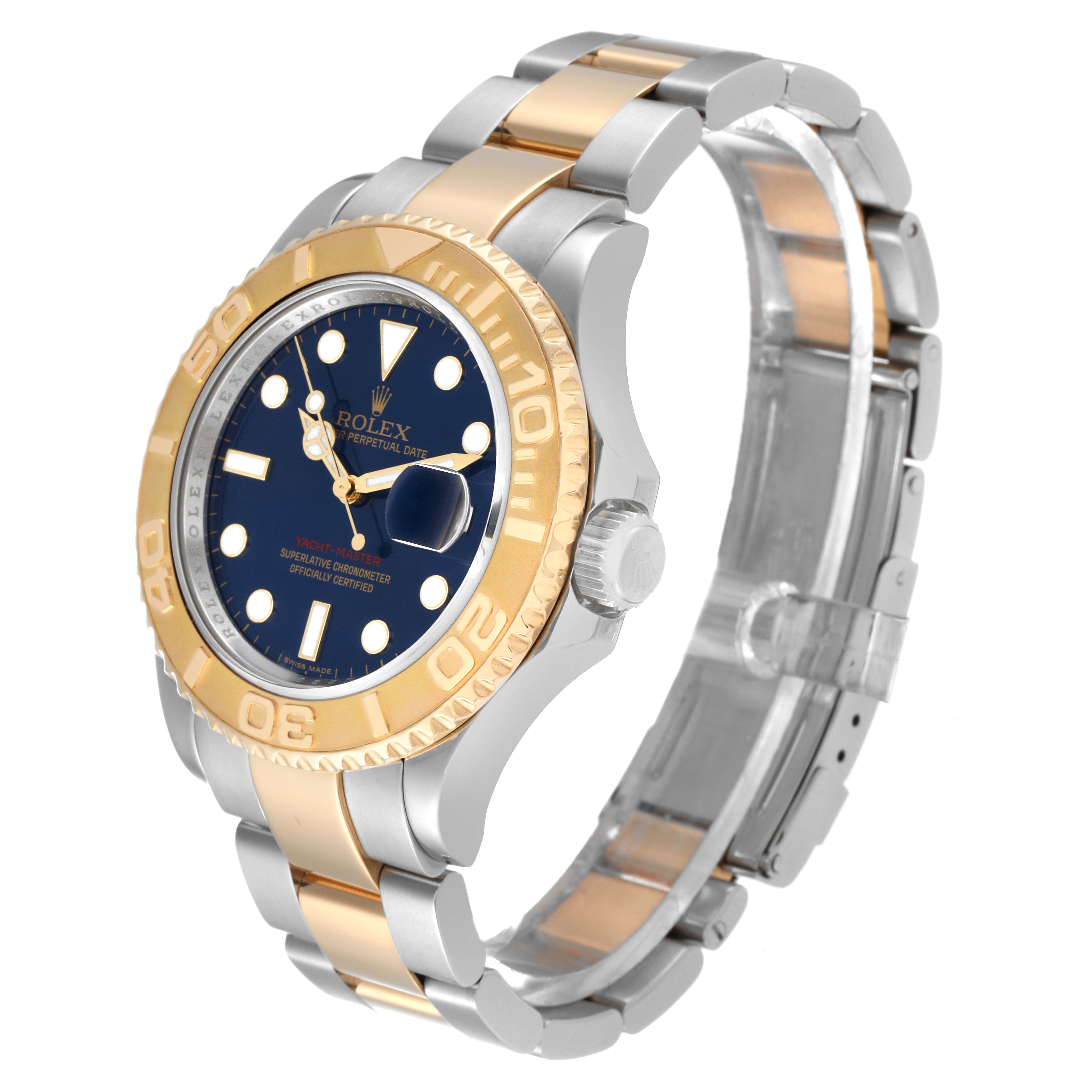 The Rolex Yacht-Master 16623 Men
s Steel and Gold (two tone) Blue Dial 16623 Men
s Steel and Gold (two tone) Blue Dial watch is shown at an angle that highlights the face, bezel, crown, and bracelet.