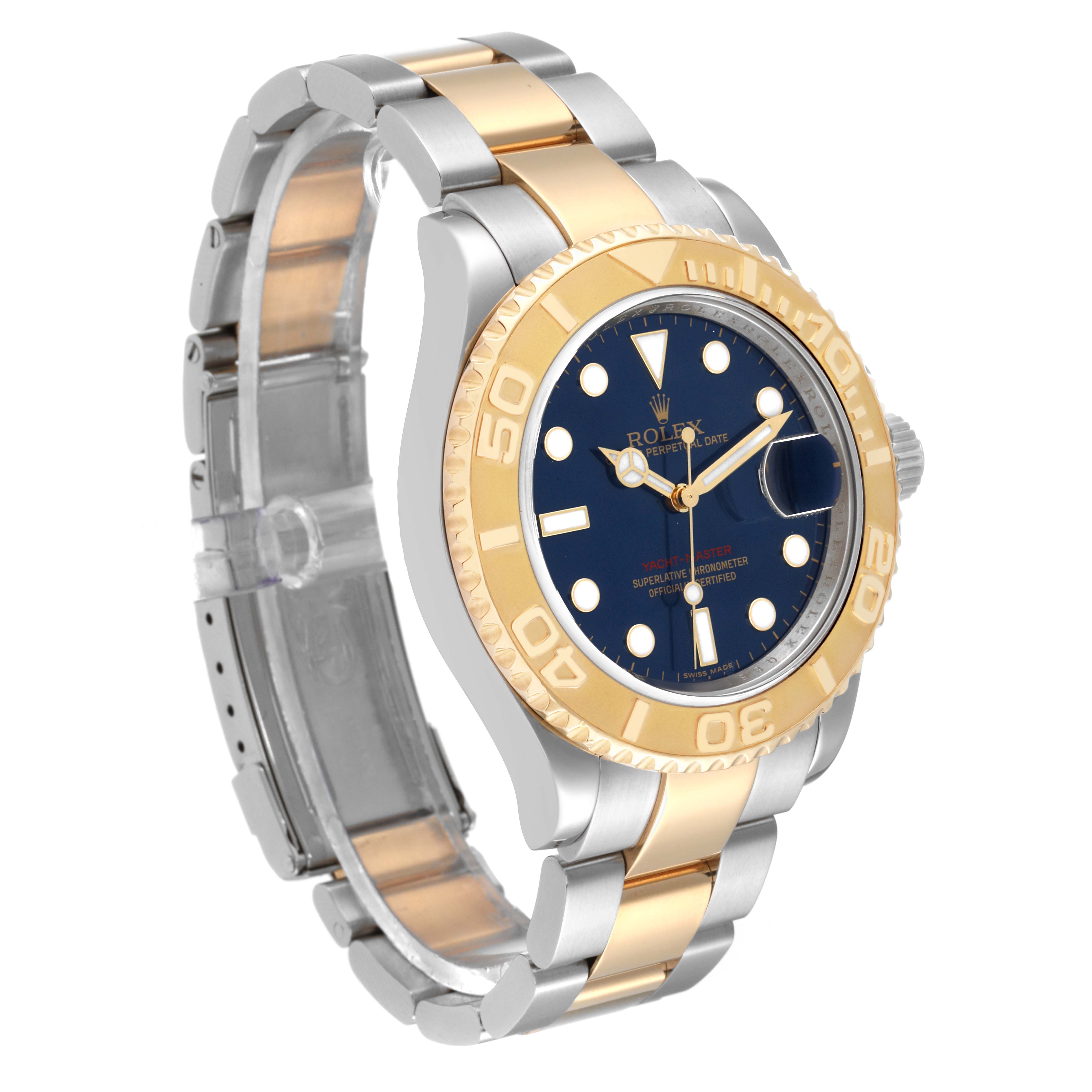 This Rolex Yacht-Master 16623 Men
s Steel and Gold (two tone) Blue Dial 16623 Men
s Steel and Gold (two tone) Blue Dial watch is shown at a three-quarter angle, highlighting its blue dial, two-tone bracelet, and bezel.