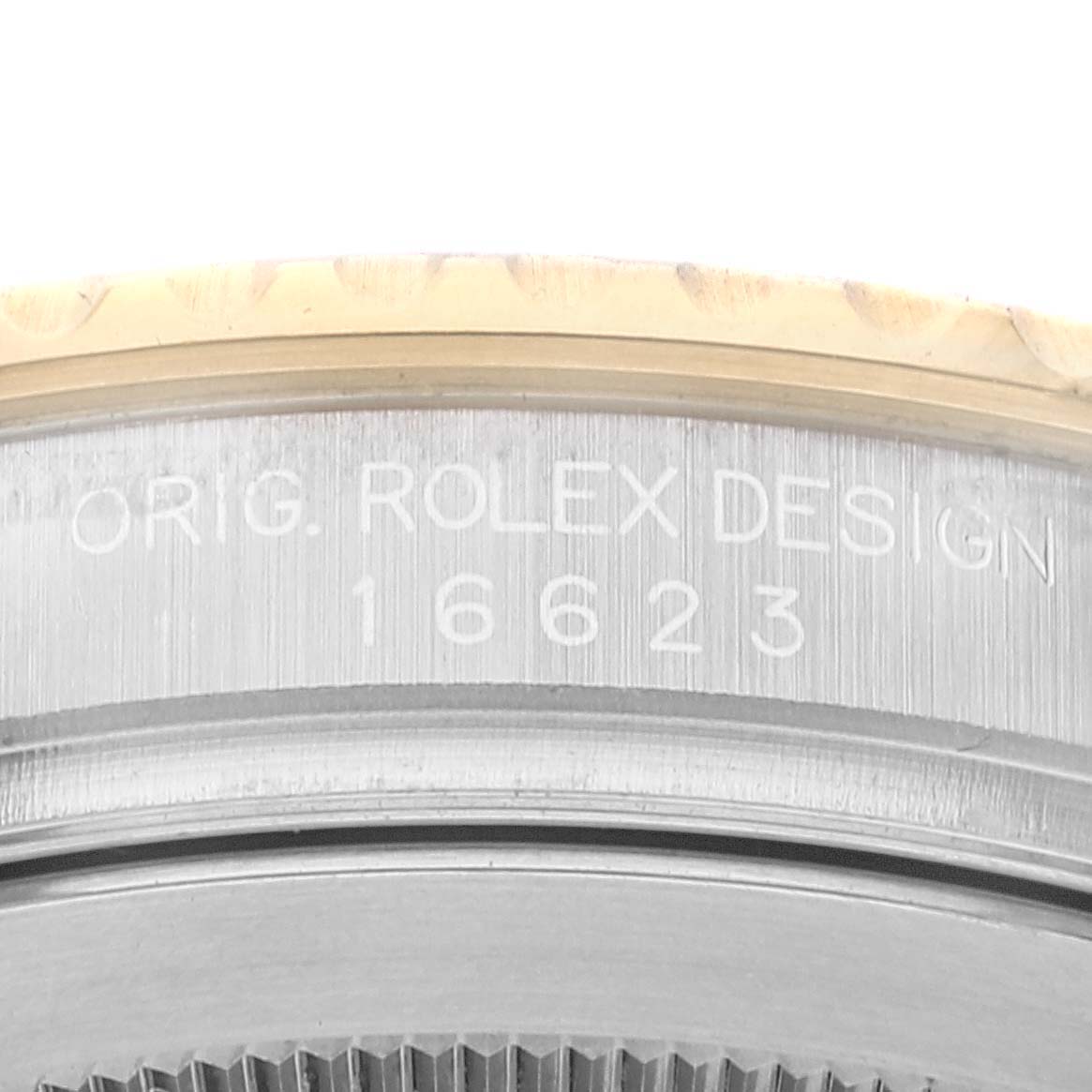 The image shows a close-up of the case back edge of the Rolex Yacht-Master 16623 Men
s Steel and Gold (two tone) Champagne Dial 16623 Men
s Steel and Gold (two tone) Champagne Dial watch, displaying the model number 16623 and the text "ORIG. ROLEX DESIGN."