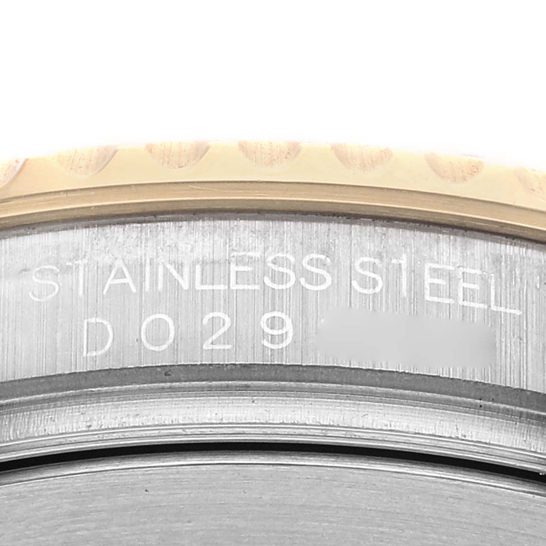 The image shows a close-up of the stainless steel case back of a Rolex Yacht-Master 16623 Men
s Steel and Gold (two tone) Champagne Dial 16623 Men
s Steel and Gold (two tone) Champagne Dial watch, with the serial number and part of the bezel visible.