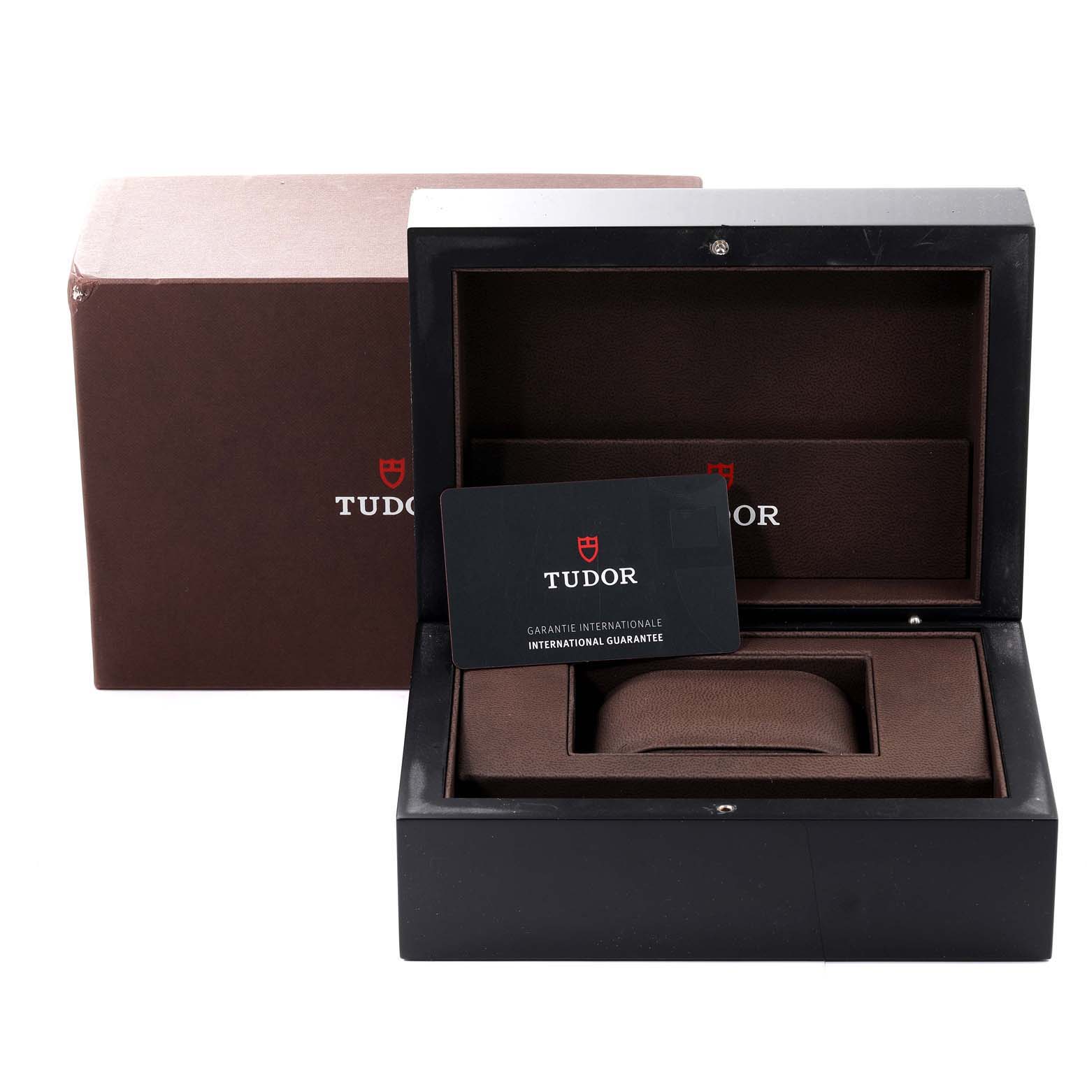 The image shows the open packaging of the Tudor Heritage Black Bay 79230DK Men's Stainless Steel Black Dial 79230DK Men's Stainless Steel Black Dial, including its box and international guarantee card.