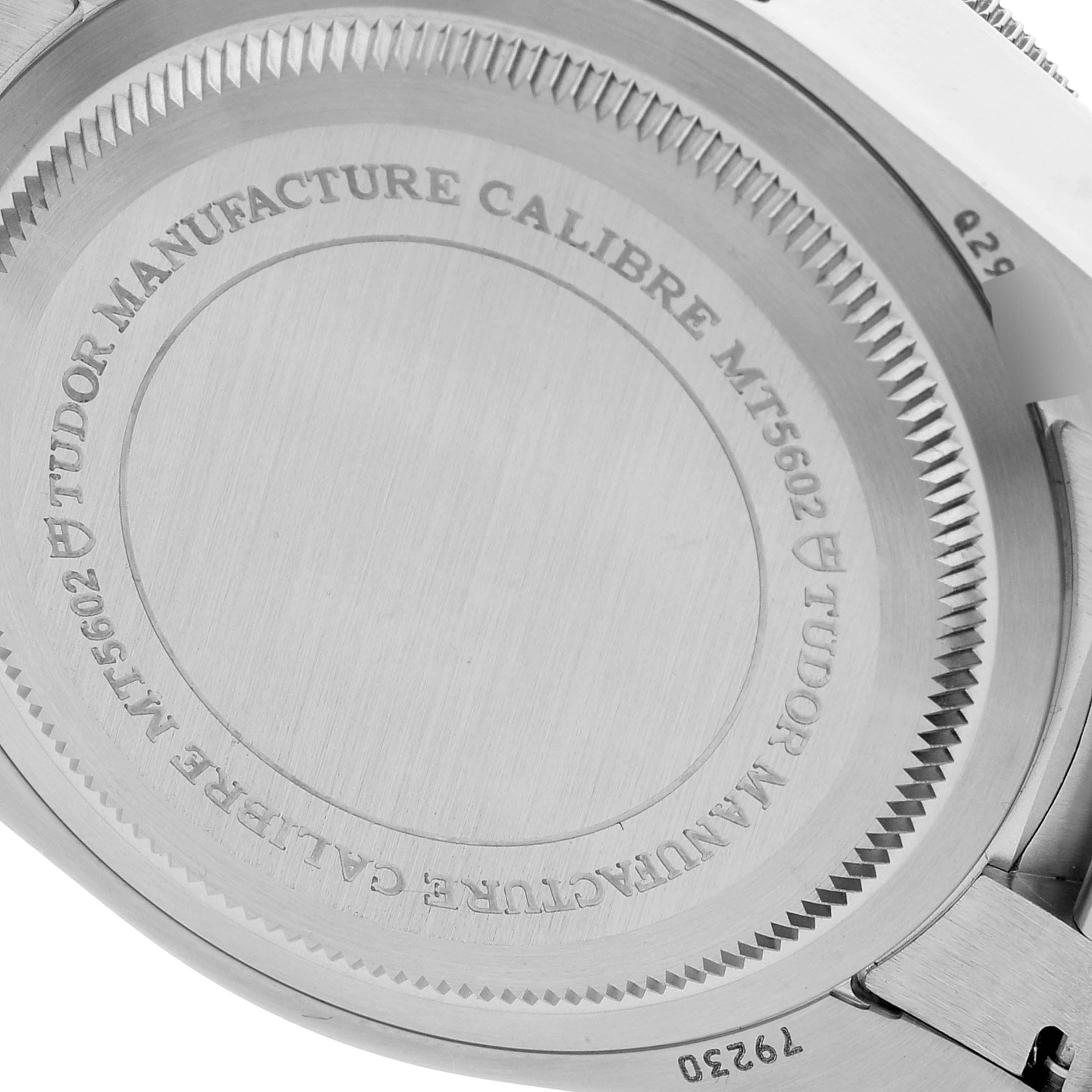 This is a close-up of the case back of the Tudor Heritage Black Bay 79230 Men's Stainless Steel Black Dial 79230 Men's Stainless Steel Black Dial watch, showing the engravings.