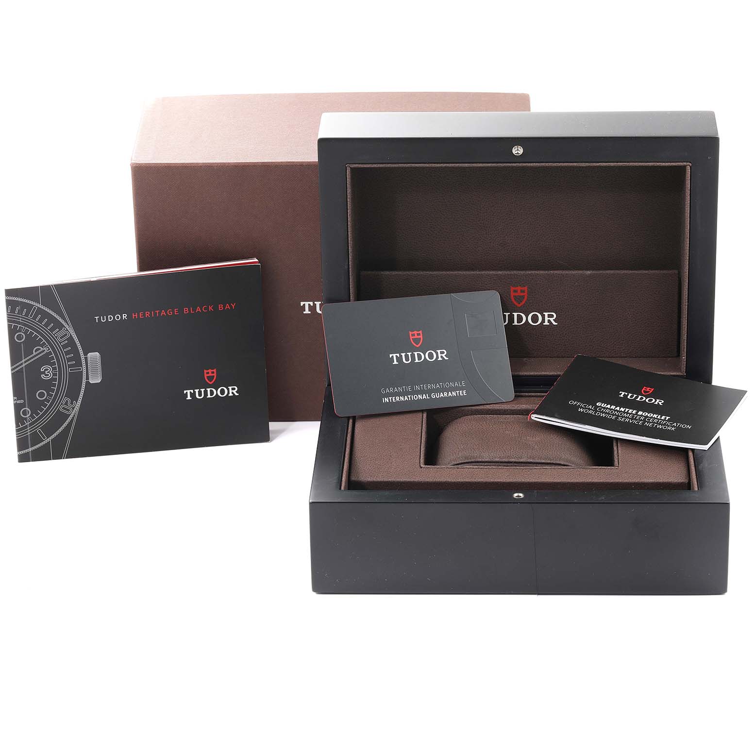 The image shows the packaging and accessories, including the box and warranty cards, for the Tudor Heritage Black Bay 79230 Men's Stainless Steel Black Dial 79230 Men's Stainless Steel Black Dial watch model.