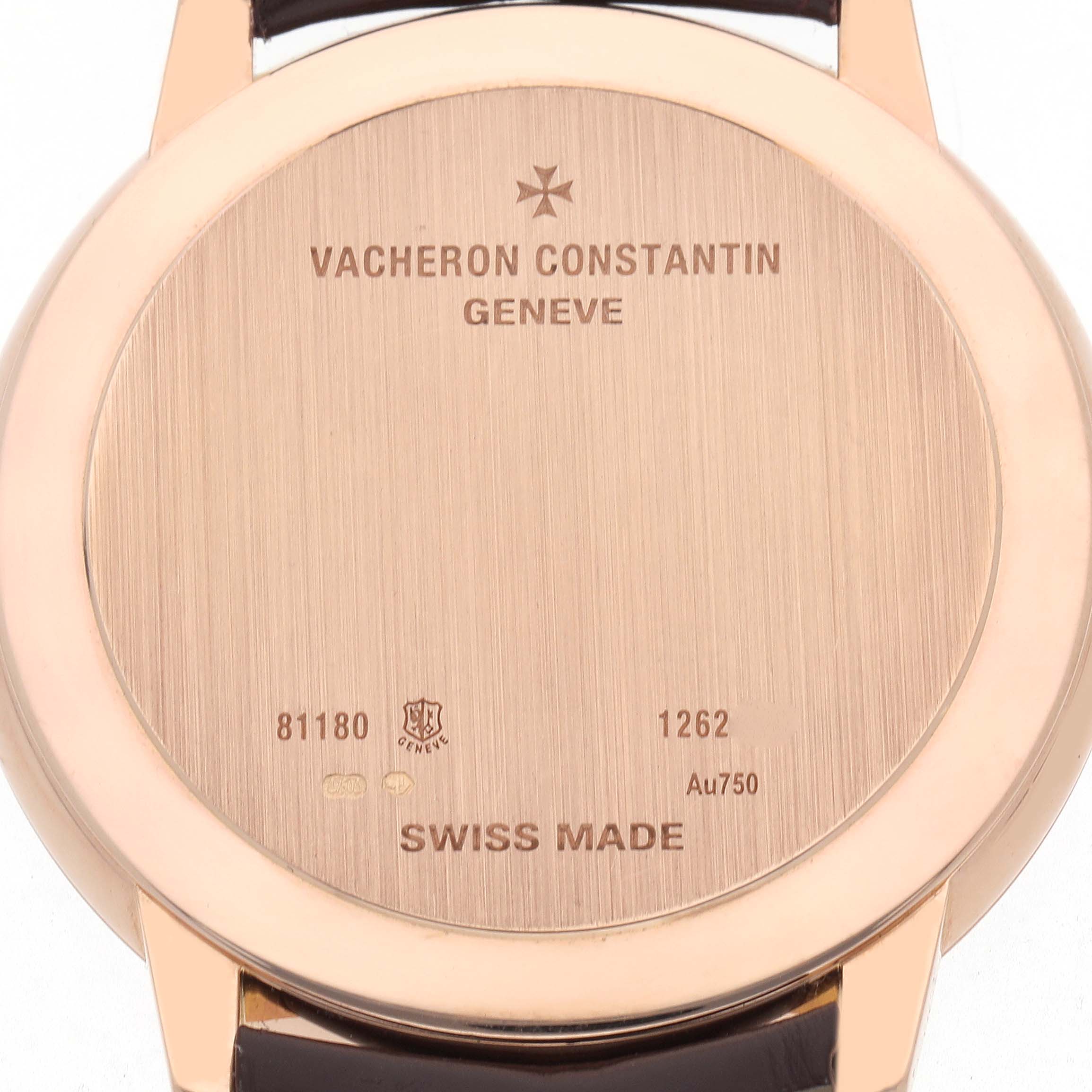 The image shows the case back of a Vacheron Constantin Patrimony 81180 Men
s Rose Gold Silver Dial watch, featuring engravings and part of the strap.