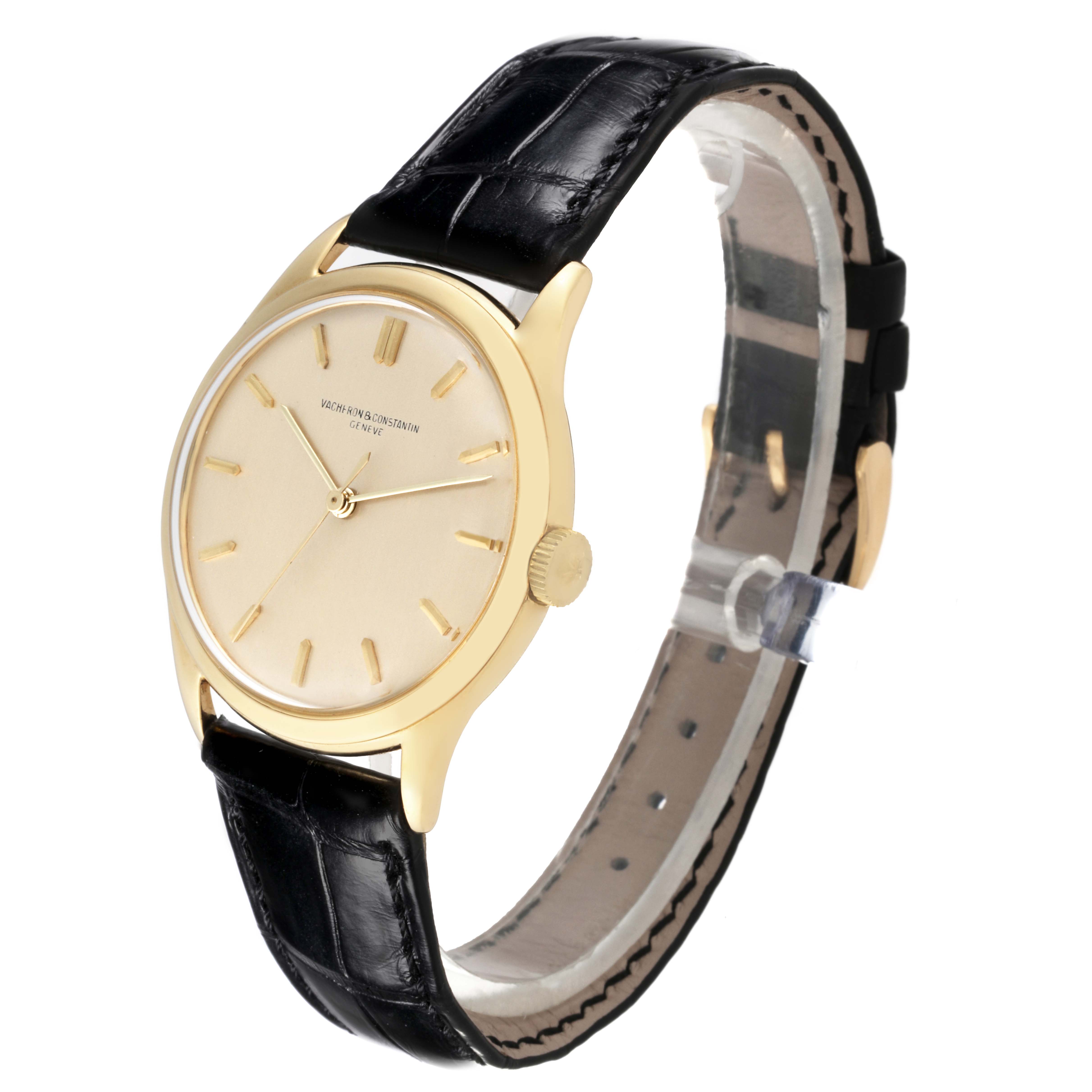 The Vintage Vacheron Constantin watch is shown at an oblique angle, highlighting the dial, gold case, crown, and black leather strap.