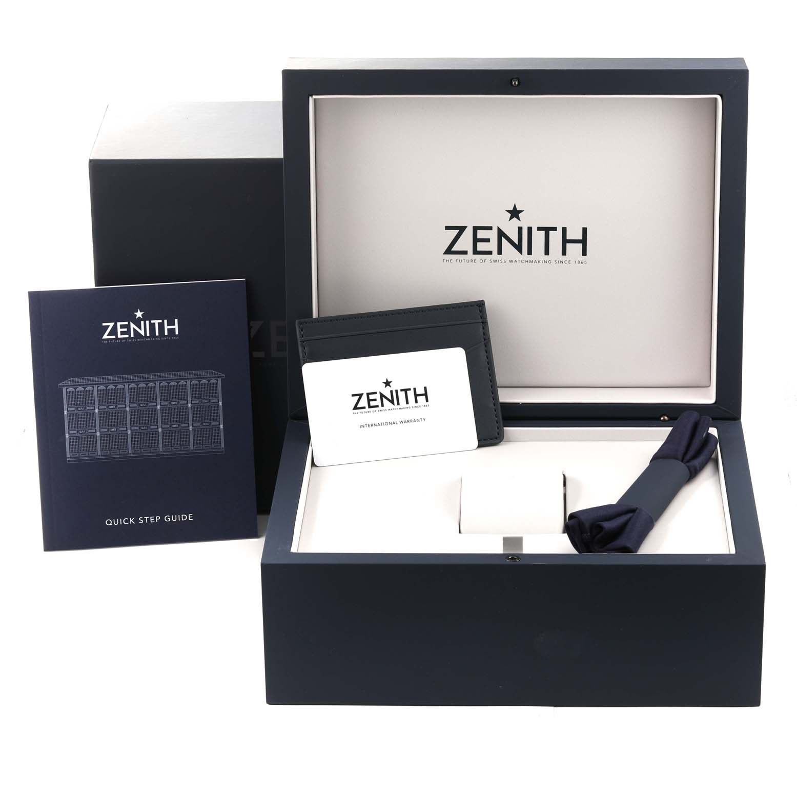 The image shows the open box and included materials for a Zenith Chronomaster 03.3105.3600 Men's Stainless Steel Blue Dial 03.3105.3600 Men's Stainless Steel Blue Dial watch, including a manual, warranty card, and other accessories.